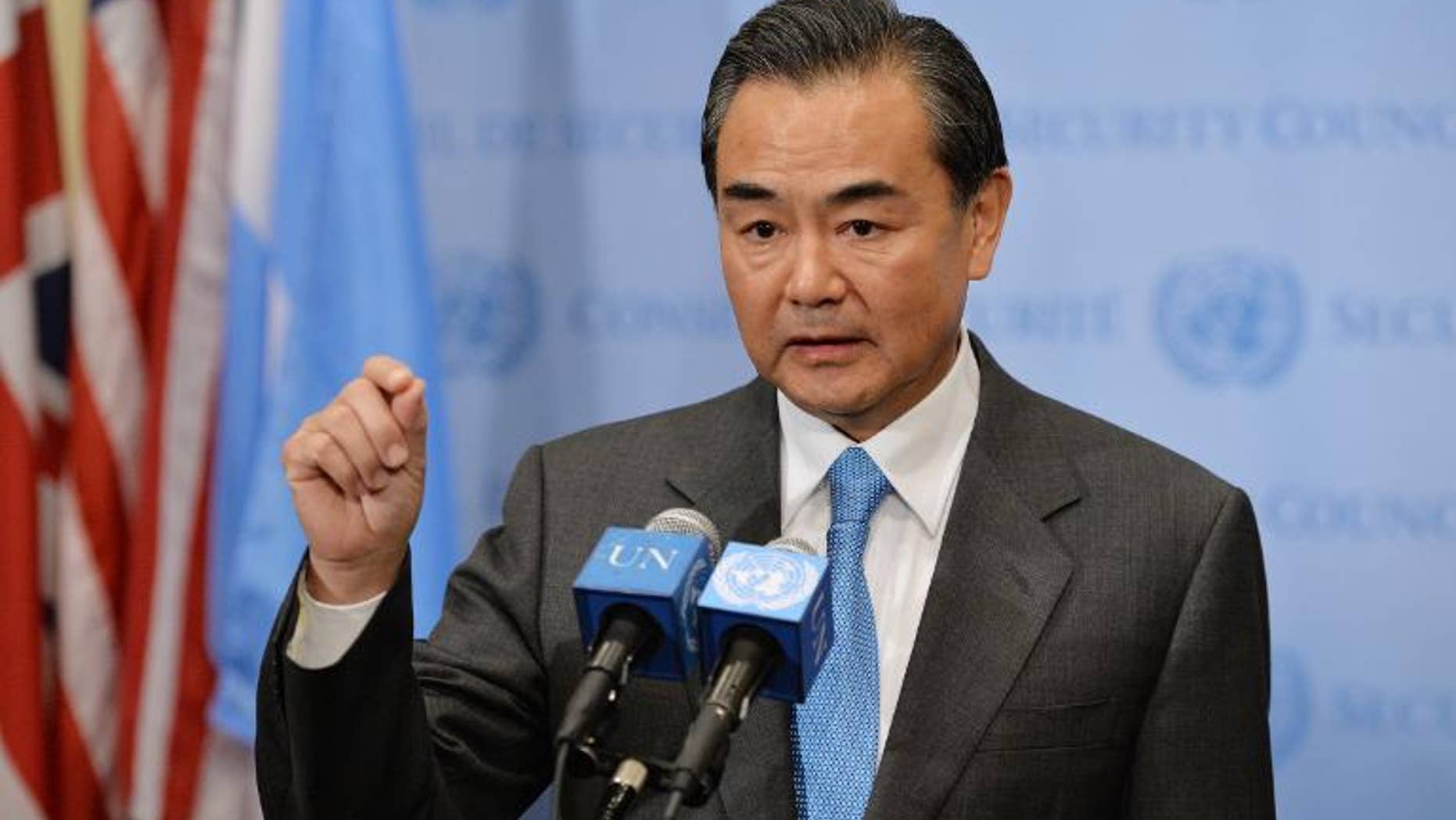 China's Foreign Minister Wang Yi speaks to the media after the UN Security Council voted to approve a resolution that will require Syria to give up its chemical weapons, on September 27, 2013 at the UN headquarters in New York