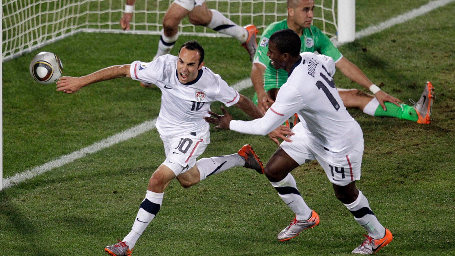 United States' Landon Donovan, front left, celebrates after scoring a goal with fellow team members United States' Clint Dempsey, back left, and United States' Edson Buddle, front right, during the World Cup group C soccer match between the United States and Algeria at the Loftus Versfeld Stadium in Pretoria, South Africa, Wednesday, June 23, 2010. (AP Photo/Michael Sohn)