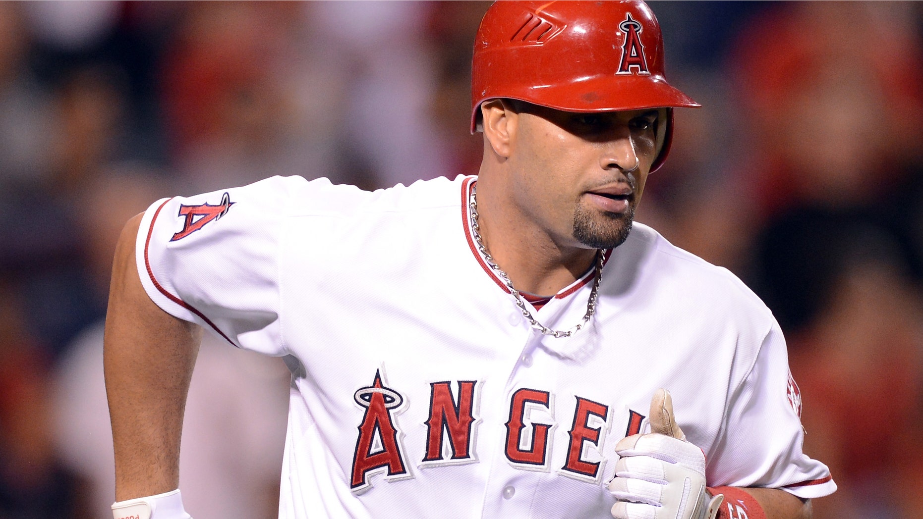 ANAHEIM, CA - SEPTEMBER 12: Albert Pujols #5 of the Los Angeles Angels reacts to his homerun to become the first player to hit at least 30 homeruns in each of his first 12 seasons during the ninth inning against the Oakland Athletics at Angel Stadium of Anaheim on September 12, 2012 in Anaheim, California. (Photo by Harry How/Getty Images)