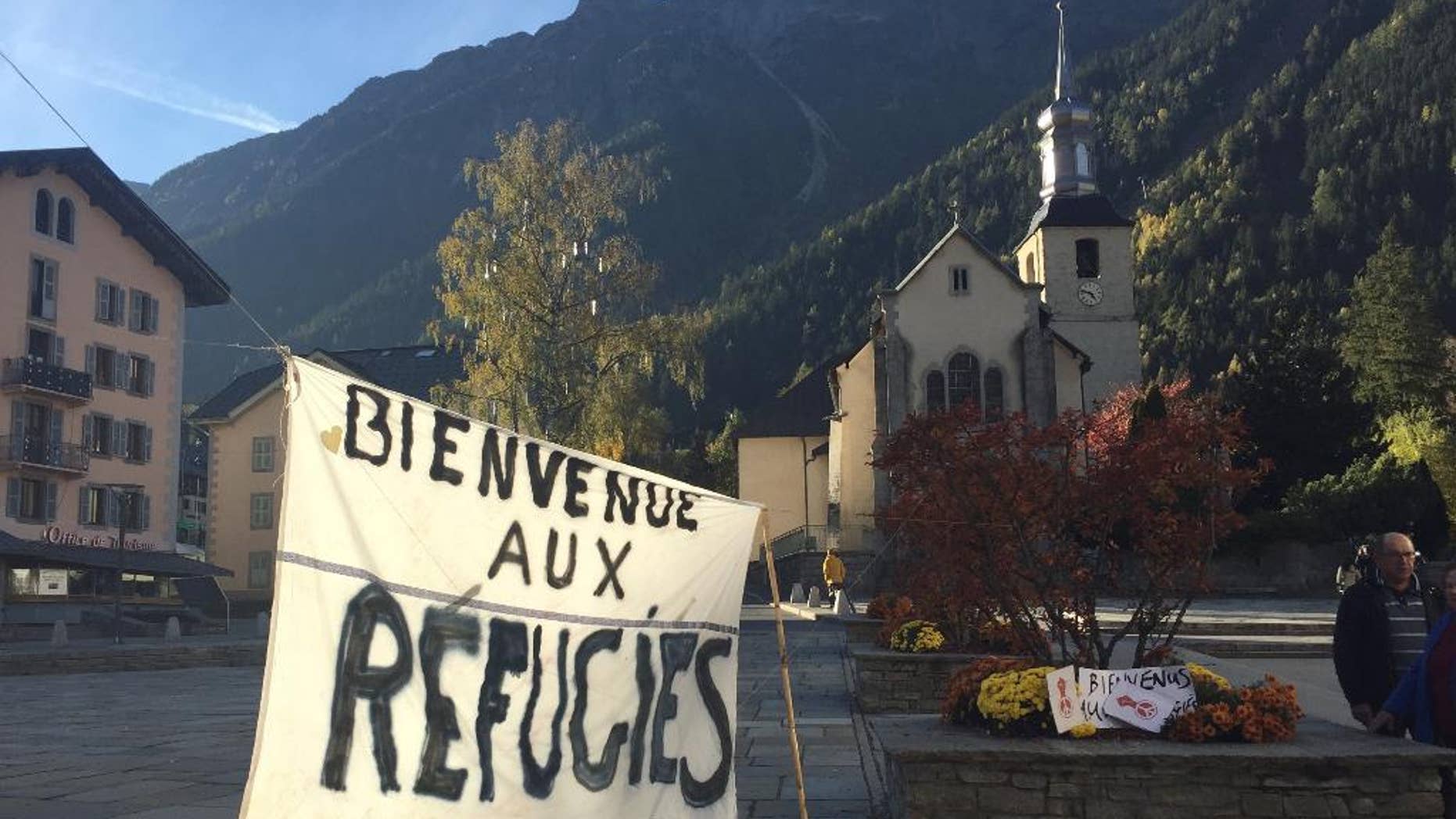 A banner set up in the main square of Chamonix, in the French Alps, reads "Welcome to Refugees" Saturday, two days before the dismantling of a refugee camp known as "The Jungle" in Calais.
