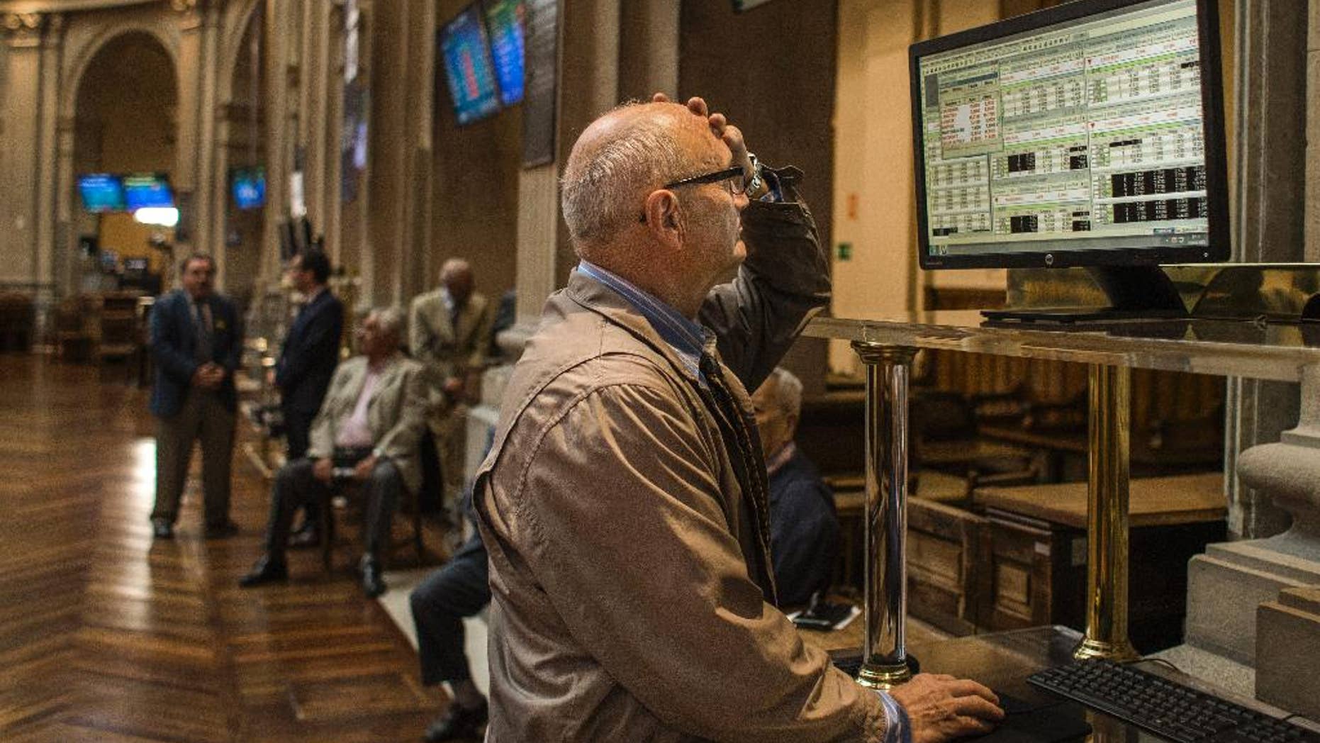 A broker gestures as he looks at a screen at the Stock Exchange in Madrid, Monday, June 29, 2015. Spain’s economy minister has said a Greek debt deal is still reachable before a deadline on the nation’s credit from the European Central Bank runs out at midnight Tuesday. Spain’s benchmark Ibex stock index slid nearly 4 percent Monday morning. (AP Photo/Andres Kudacki)