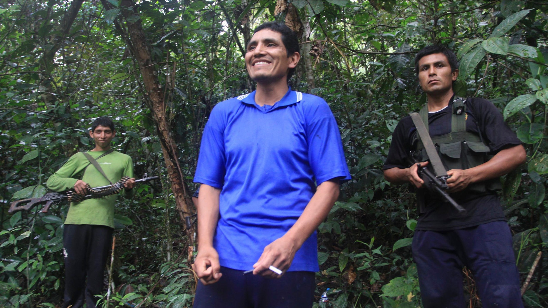 In this photo taken Tuesday, April 17, 2012, Martin Quispe Palomino, also known as "Comrade Gabriel," center, a member of the Shining Path rebel force, talks with a group of journalist in Alto Laguna, Peru. Comrade Gabriel is the youngest of the three Quispe Palomino brothers who command about 500 combatants of a retooled and well-disciplined new Shining Path that has taken firm root in the worldâs leading cocaine-producing valley. (AP Photo/La Republica Newspaper, Luis Saldana)