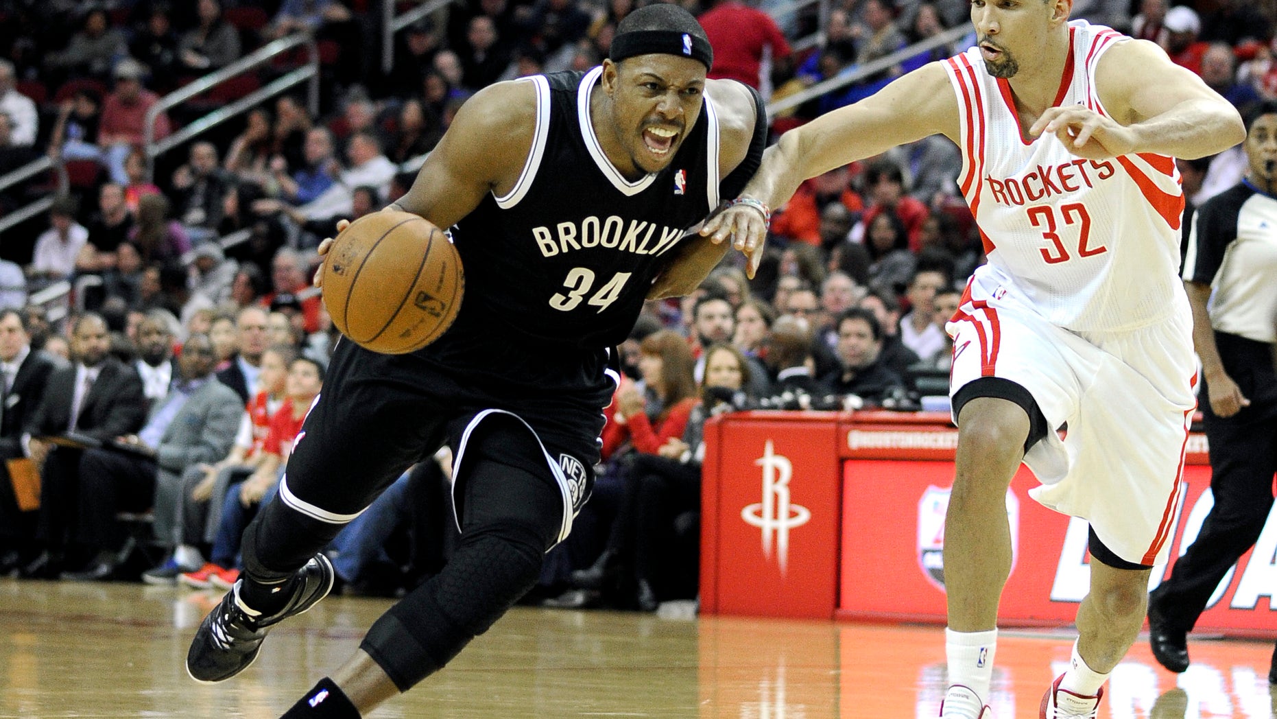 Brooklyn Nets' Paul Pierce (34) drives the ball past Houston Rockets' Francisco Garcia (32) in the first half of an NBA basketball game on Friday, Nov. 29, 2013, in Houston. (AP Photo/Pat Sullivan)
