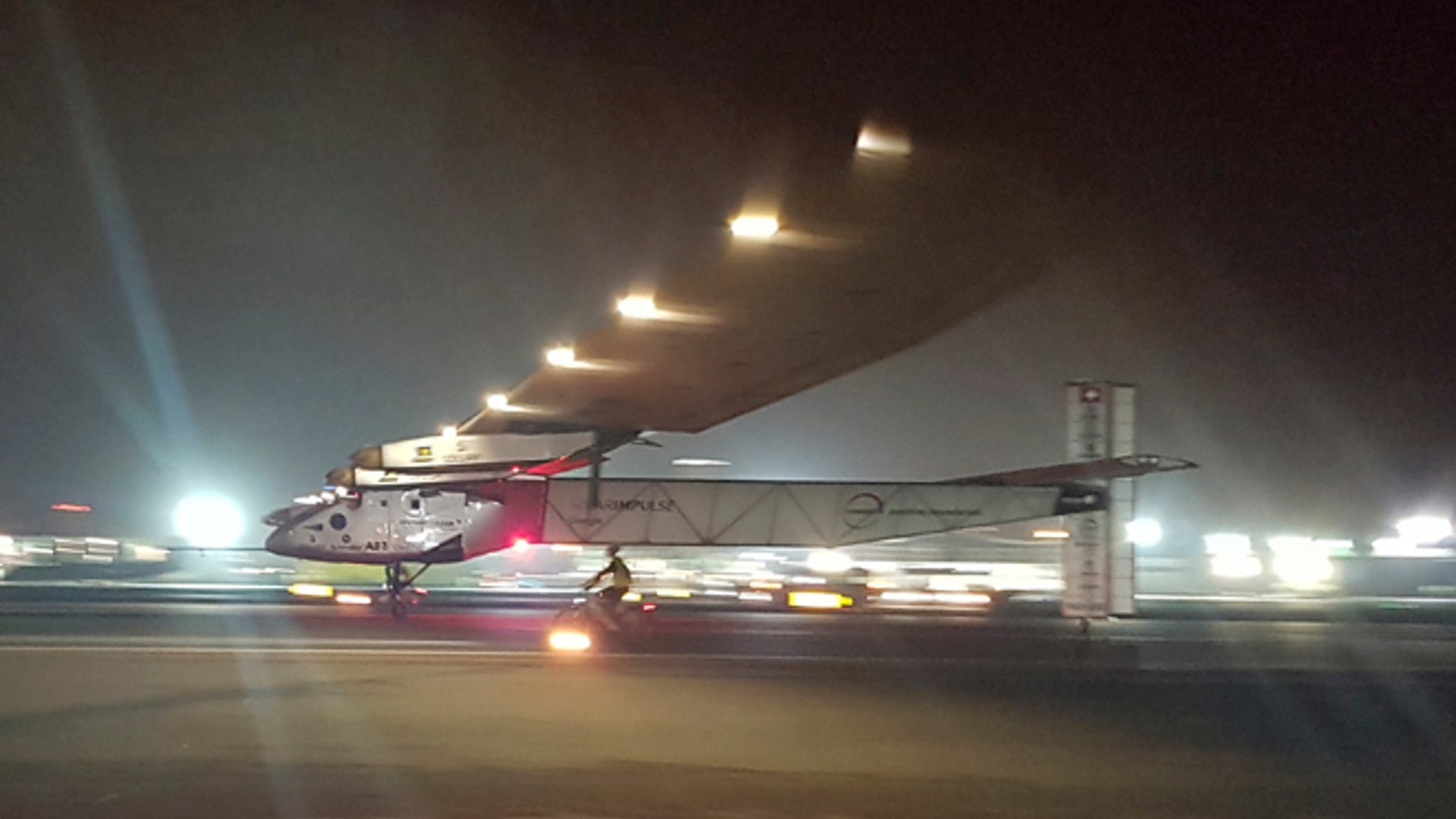 The Solar Impulse 2 plane lands in an airport in Abu Dhabi, United Arab Emirates, early Tuesday, July 26, 2016, marking the historic end of the first attempt to fly around the world without a drop of fuel, powered solely by the suns energy. (AP Photo/Aya Batrawy)