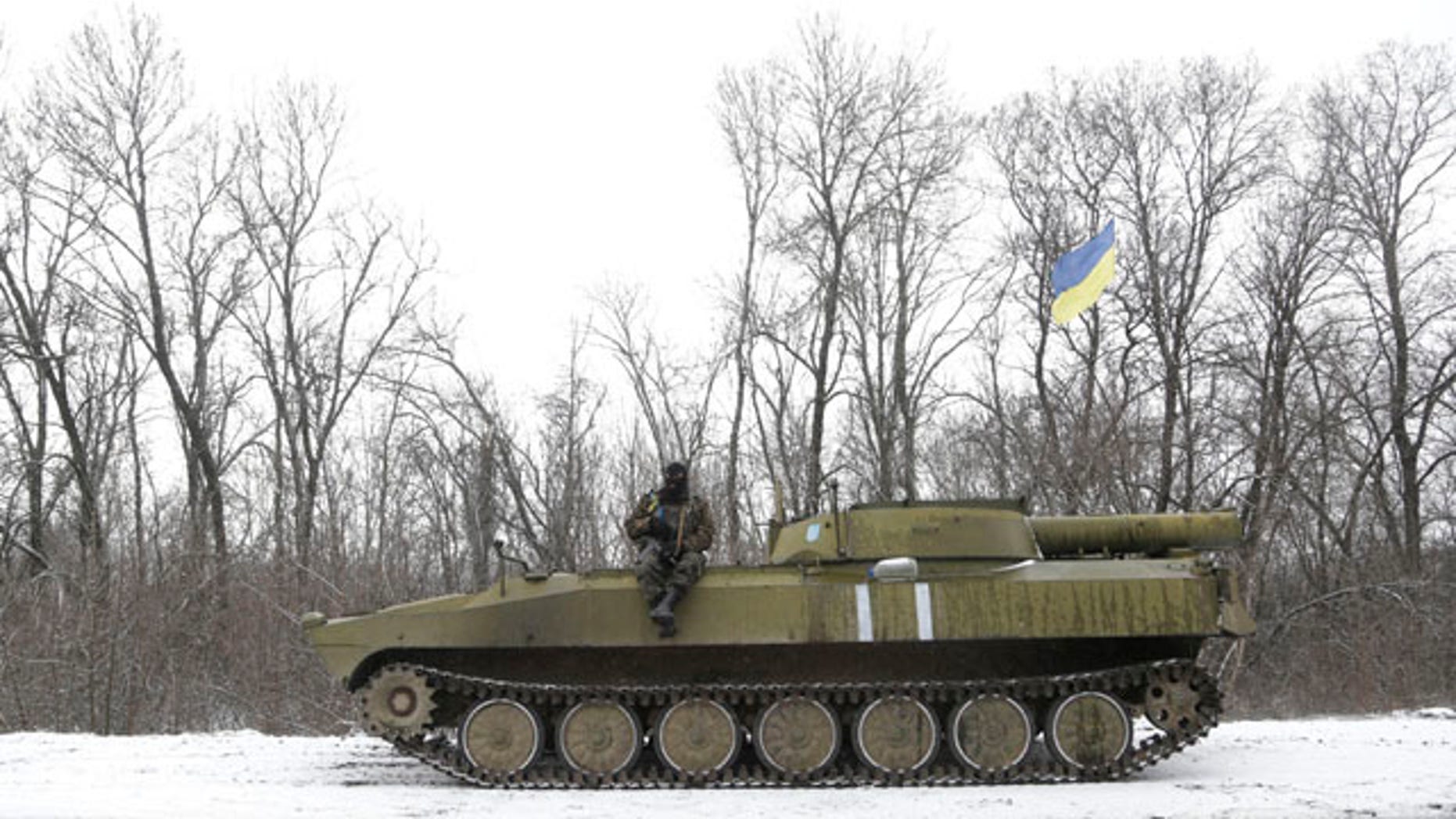 Feb. 16, 2015: An Ukrainian soldier rests on his vehicle near the road between the towns of Debaltseve and Artemivsk. (AP Photo/Petr David Josek)