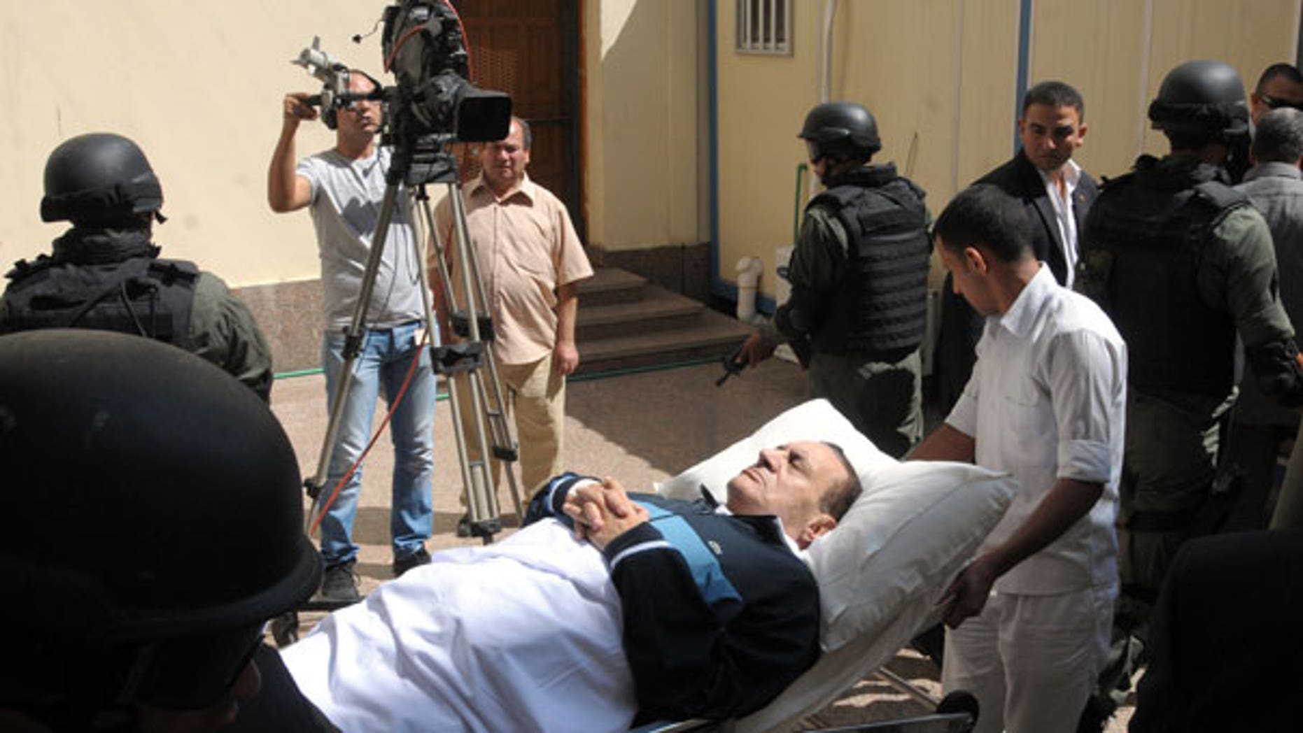 Sept. 7: Former Egyptian president Hosni Mubarak lies on his bed while being taken to the courtroom for another session of his trial in Cairo, Egypt.