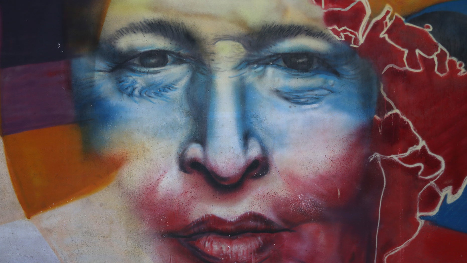 CARACAS, VENEZUELA - MARCH 04: A mural honors former Venezuelan president Hugo Chavez near the military barracks where Chavez is entombed on March 4, 2014 in Caracas, Venezuela. Workers made last minute preparations for Wednesday's ceremony marking the first anniversary of Chavez' death on March 5, 2013. The anniversary has been marred by three weeks protests against the government of Chavez' chosen successor Nicolas Maduro. (Photo by John Moore/Getty Images)