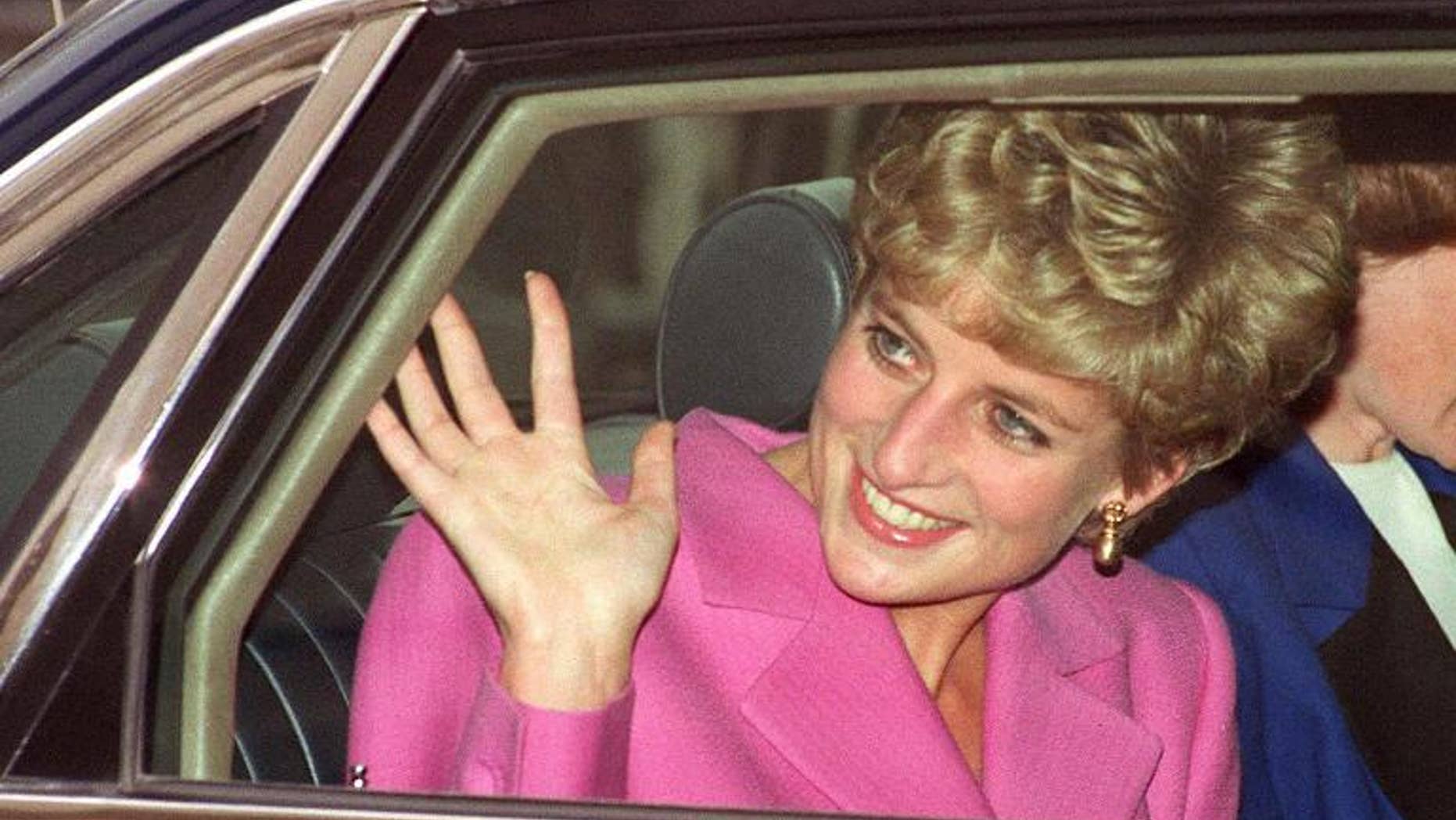Diana, Princess of Wales waves to the crowd as she arrives at the Cite de la Musique at La Villette in Paris on November 14, 1992