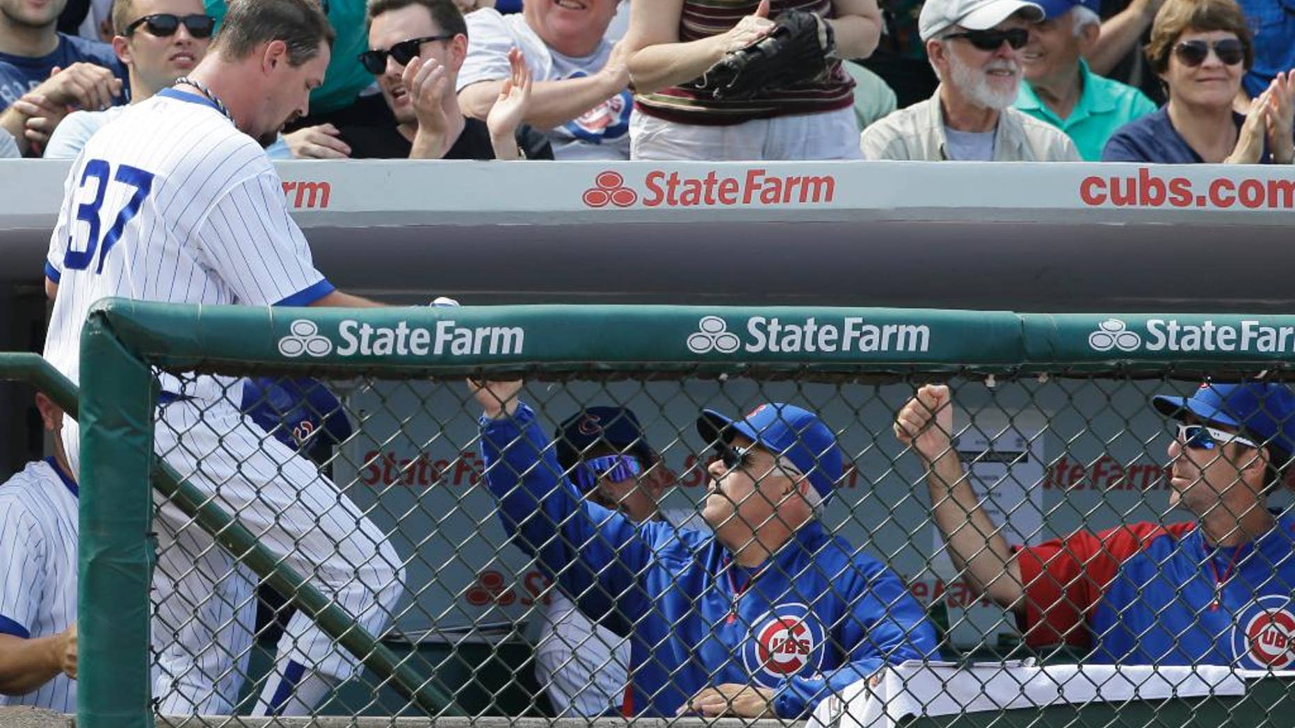 Chicago Cubs' Travis Wood, left, celebrates with manager Rick Renteria after scoring on a single hit by Javier Baez during the fifth inning of an interleague baseball game against the Tampa Bay Rays in Chicago, Sunday, Aug. 10, 2014. (AP Photo/Nam Y. Huh)