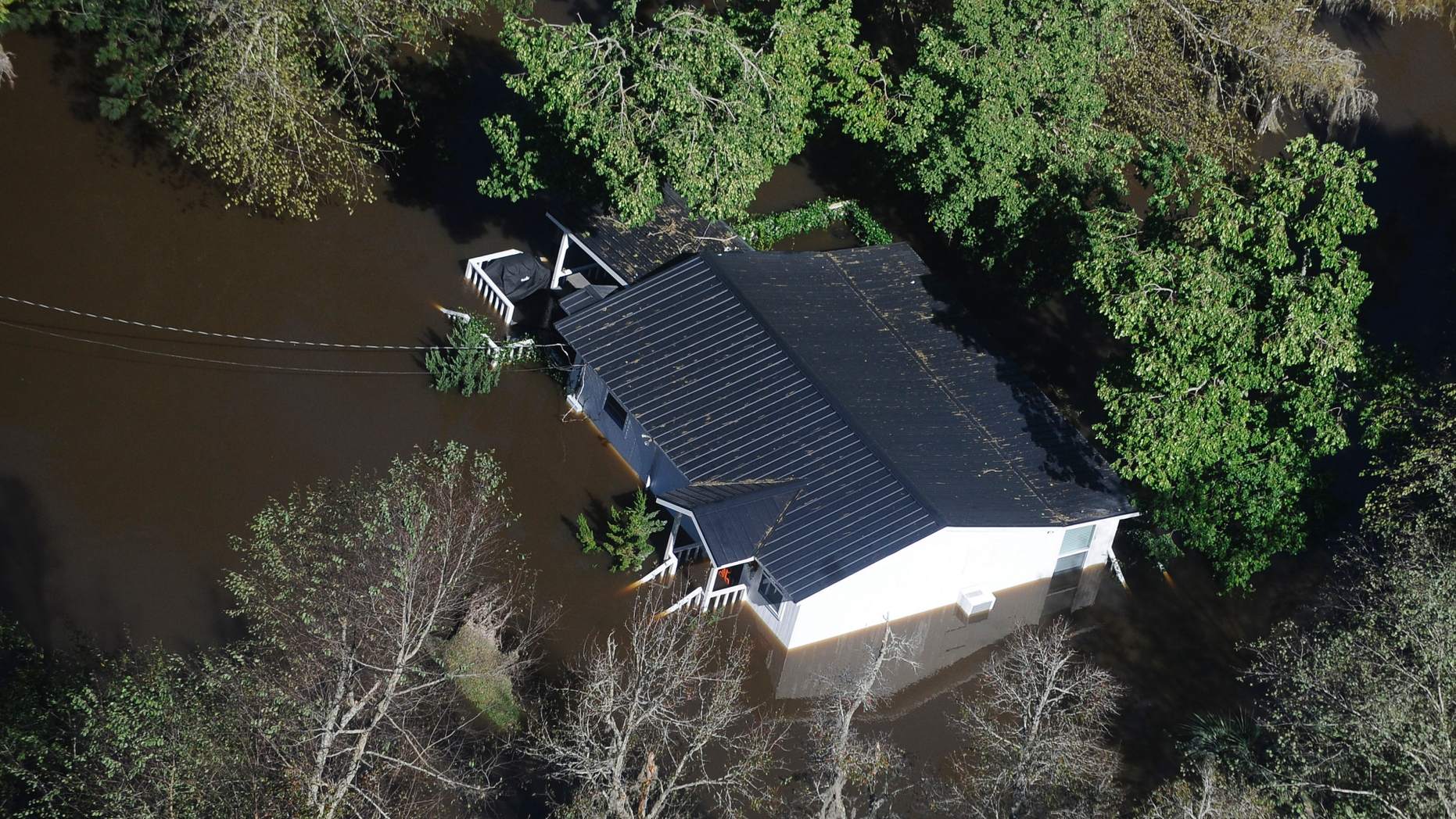 FILE-In this Monday, Oct. 10, 2016 file photo, a home sits in flood waters in Nichols, S.C. The residents of a tiny town in South Carolina who rebuilt after an inland flood from a hurricane destroyed 90 percent of the homes two years ago are uneasy as forecasters warn inland flooding from Hurricane Florence's rain could be one of the most dangerous and devastating parts of the storm. (AP Photo/Rainier Ehrhardt, File)