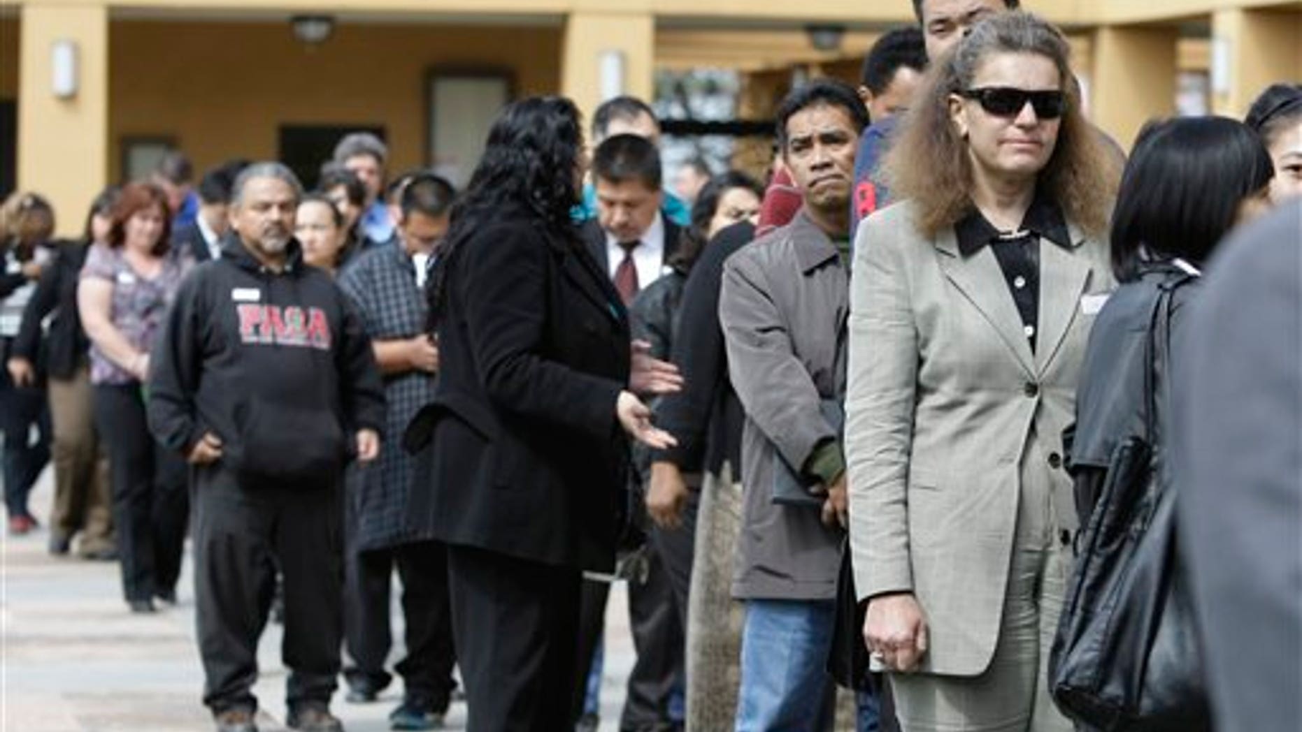 Job applicants wait in line at a job fair in San Jose, California.