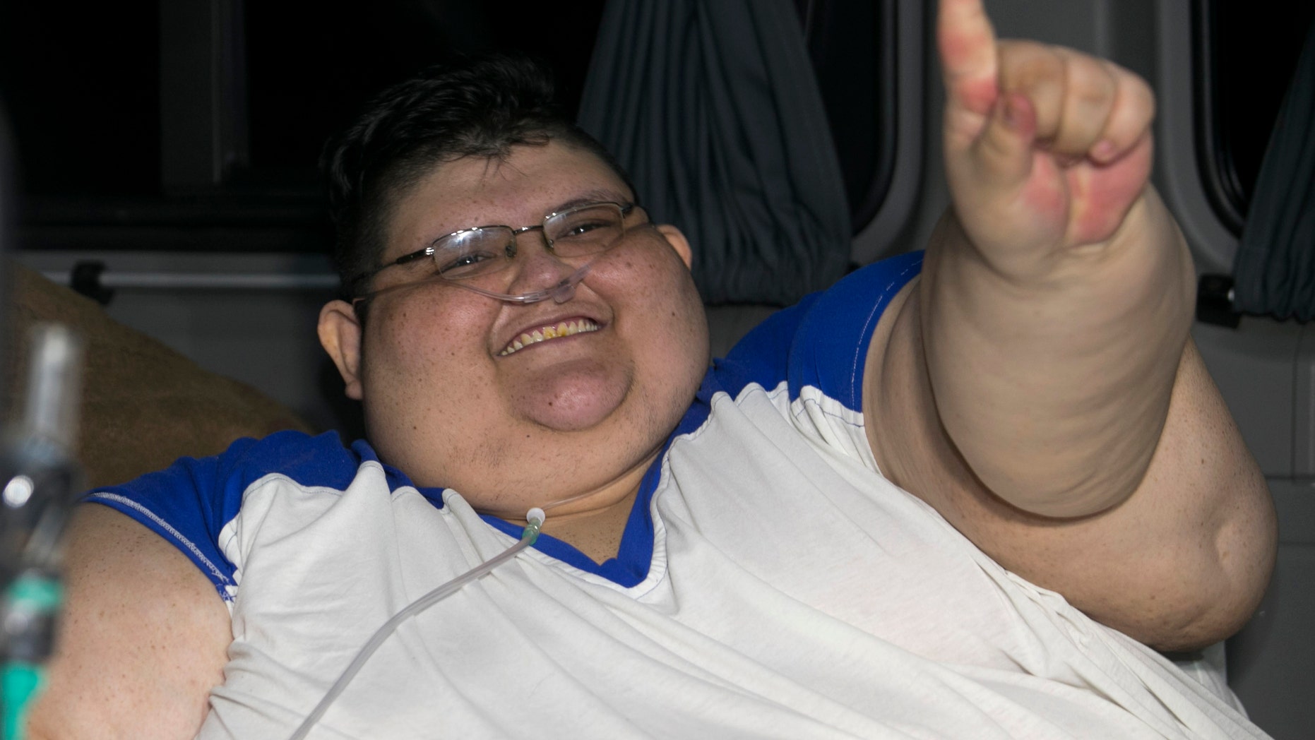 Juan Pedro smiles on arrival at hospital in Guadalajara, Mexico, Tuesday, Nov. 15, 2016. Juan Pedro,who weighs about 1,100 pounds (500 kilos) and hasn't left his bed in six years has been removed by medical personnel for treatment. His doctor gave the man's name only as Juan Pedro, 32, from the central city of Aguascalientes. (AP Photo/Refugio Ruiz)
