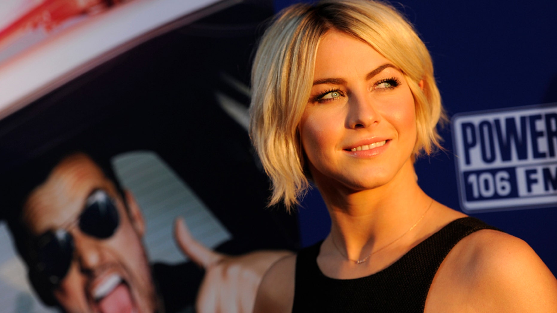 Actress Julianne Hough looks back for photographers at the premiere of the film "Let's Be Cops" on Thursday, Aug. 7, 2014, in Los Angeles.
