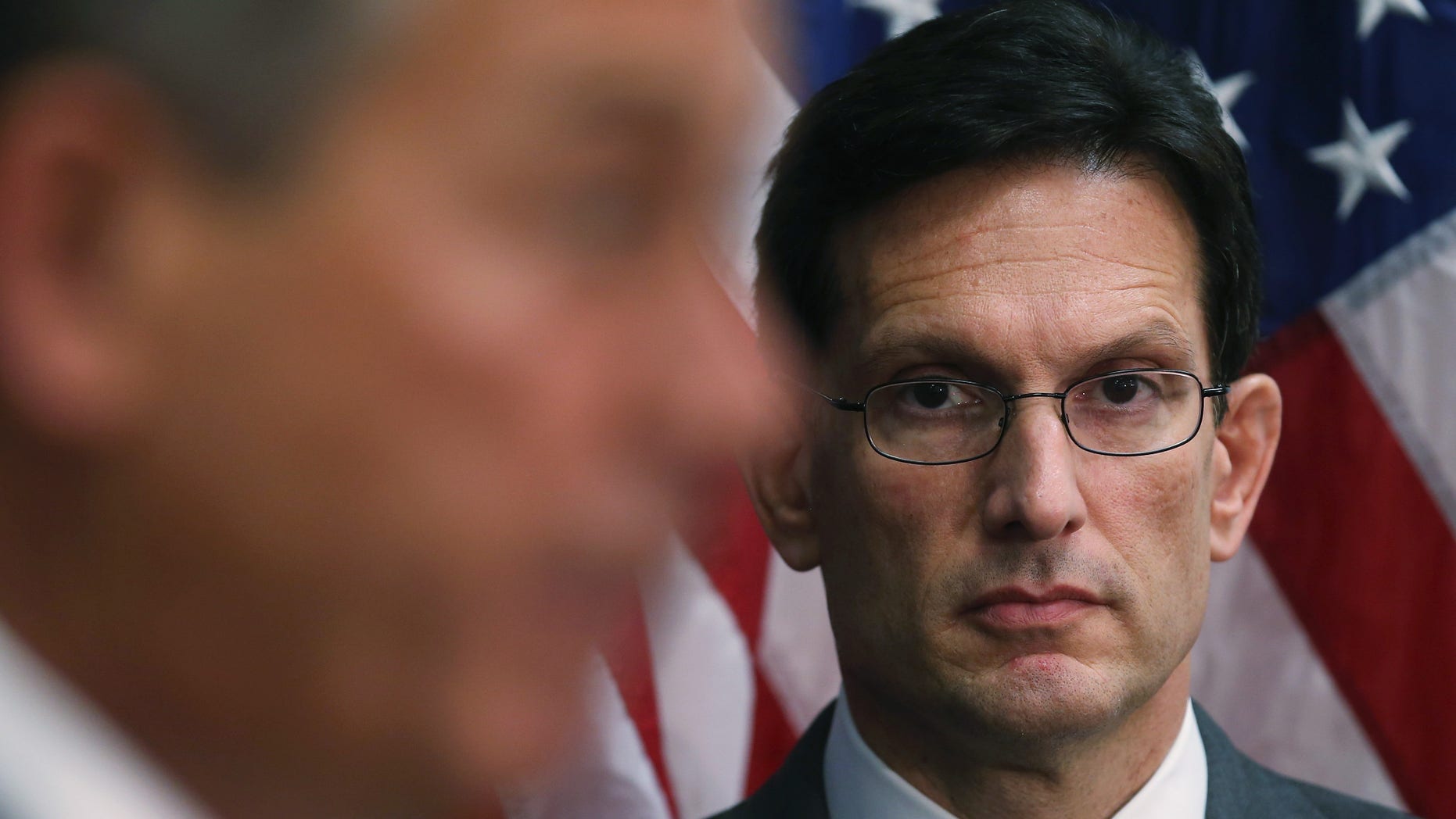 WASHINGTON, DC - MARCH 25: House Majority Leader Eric Cantor (R-VA) (R) listens to House Speaker John Boehner (R-OH) (L) speak after attending the weekly House Republican conference at the U.S. Capitol March 25, 2014 in Washington, DC. Speaker Boehner spoke on various issues including jobs and the unemployment rate. (Photo by Mark Wilson/Getty Images)