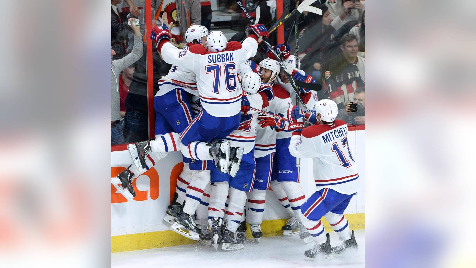 Montreal Canadiens celebrate their 2-1 victory over the Ottawa Senators in sudden death overtime of game 3 of first round Stanley Cup NHL playoff hockey action in Ottawa, Ontario, on Sunday, April 19, 2015. (Sean Kilpatrick/The Canadian Press via AP) MANDATORY CREDIT