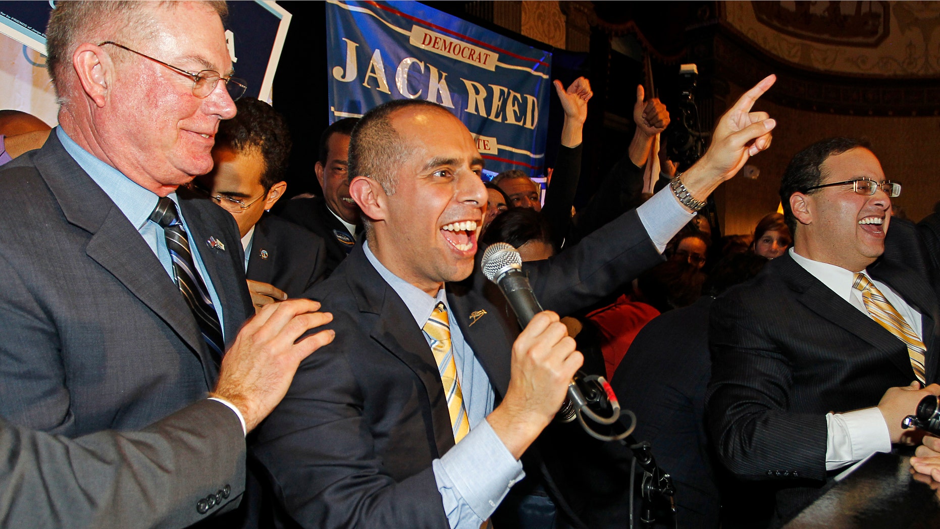 Democrat Jorge Elorza, center, celebrates his win over Independent Vincent Cianci, Jr. in the Providence mayoral race, Tuesday, Nov. 4, 2014, in Providence, R.I.. (AP Photo/Stew Milne)