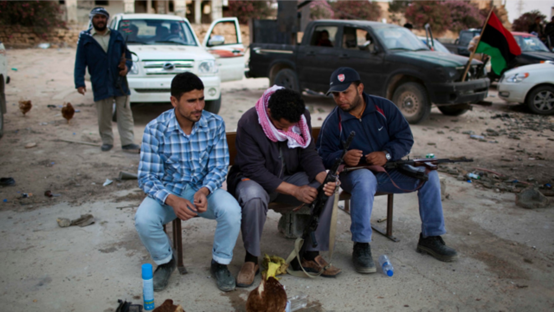 May 25: Rebel fighters clean their weapons near the east front line, 25 kilometers from Misrata, Libya.