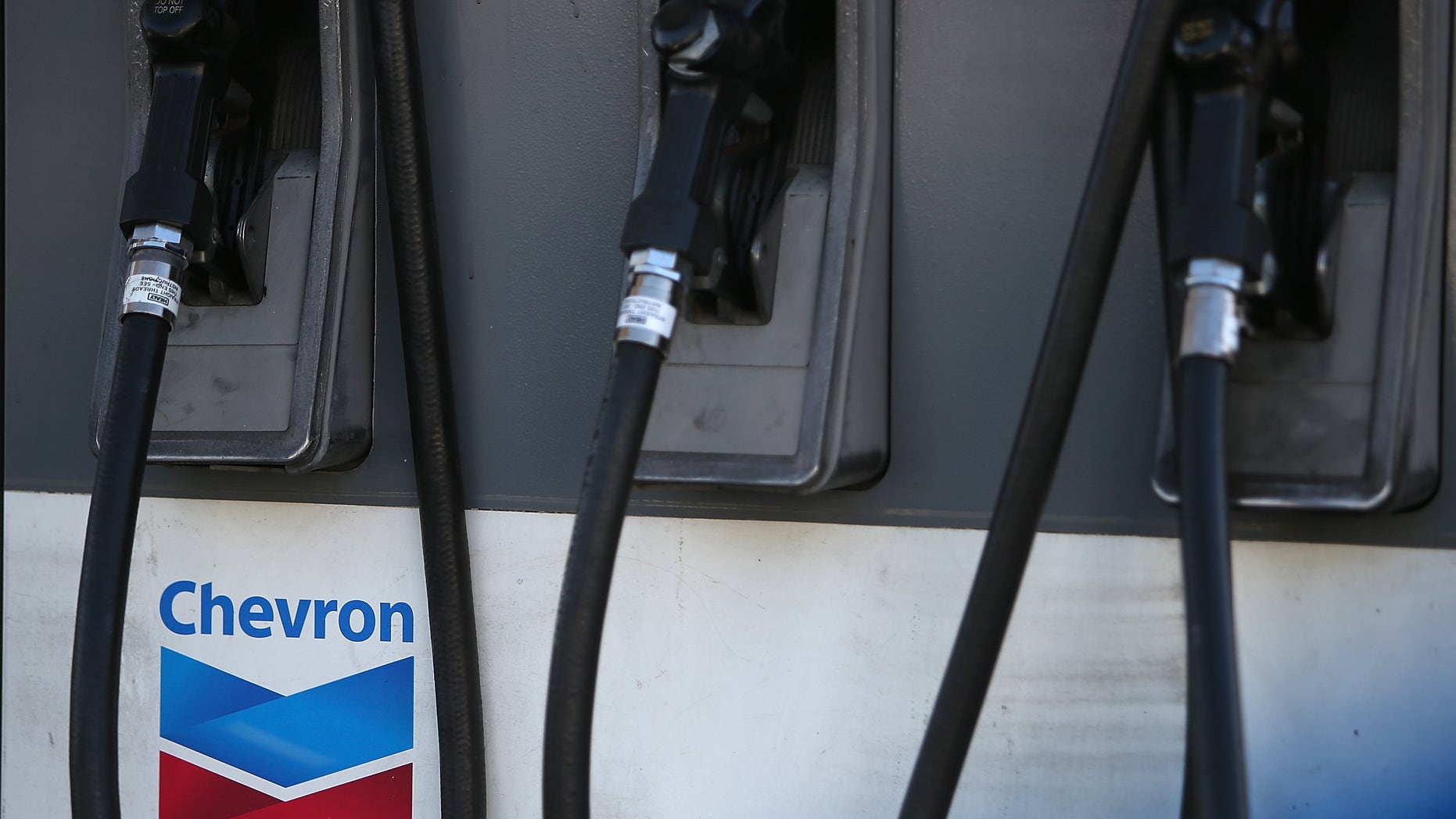 SAN FRANCISCO, CA - MAY 02: The Chevron logo is displayed on a gas pump at a Chevron gas station on May 2, 2014 in San Francisco, California. Chevron Corp. reported a 27 percent plunge in first quarter profits with earnings of $4.51 billion, or $2.36 a share, compare to $6.18 billion, or $3.18 a share, one year ago. (Photo by Justin Sullivan/Getty Images)