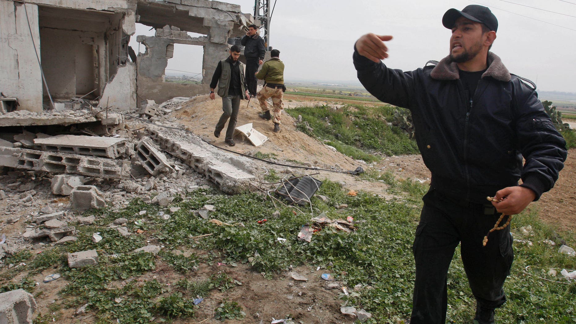 A Palestinian Hamas member inspect the damage after an Israeli strike in east of Gaza strip, Saturday, March 19, 2011. Israeli police say Hamas militants in Gaza have launched the heaviest shelling in more than two years on Israeli border communities, lightly injuring two civilians. A Gaza Health Ministry official said Israel's subsequent airstrikes killed a member of Hamas and injured two others.
