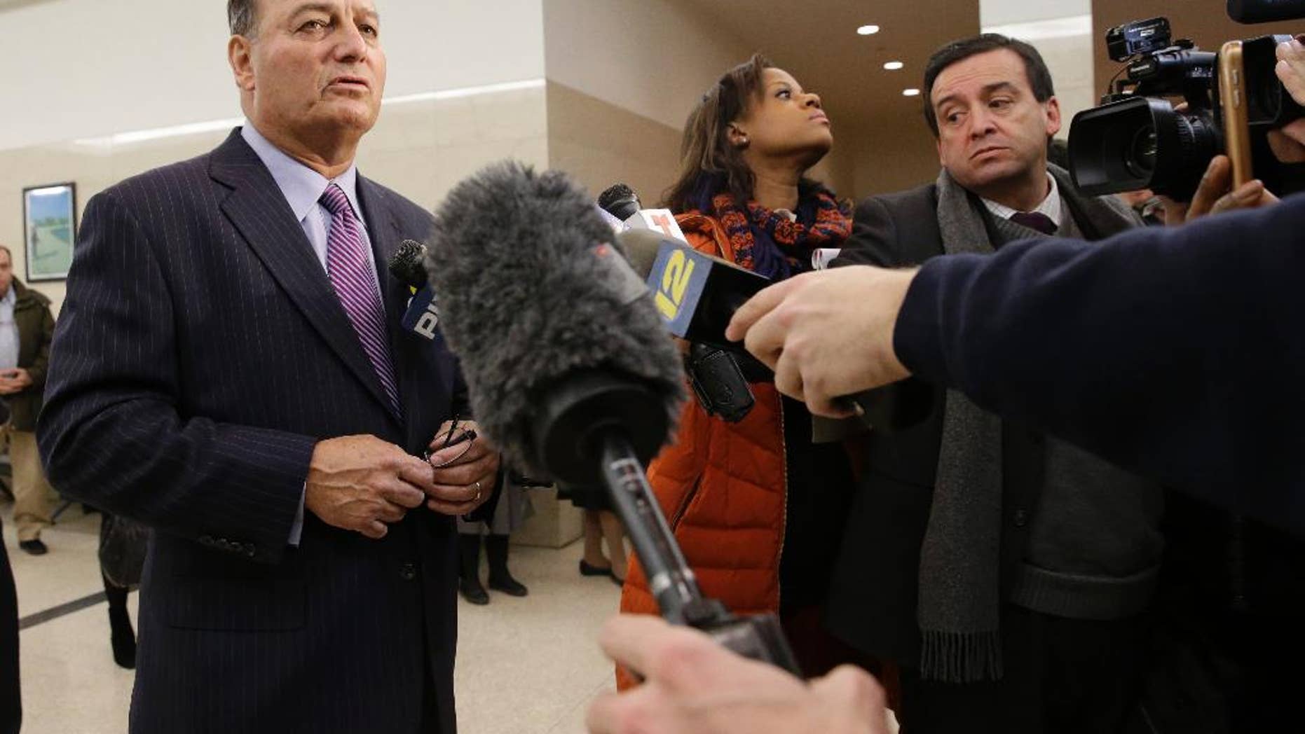 Stephen C, Worth, left, attorney for New York City police officer Peter Liang, speaks to reporters after Liang's arraignment at Brooklyn Superior court, Wednesday, Feb. 11, 2015, in New York. Liang, who fired into a darkened stairwell last November at a Brooklyn public housing complex, accidentally killing 28-year-old Akai Gurley, has been charged with manslaughter, official misconduct and other charges. He was released without bail. (AP Photo/Mary Altaffer)