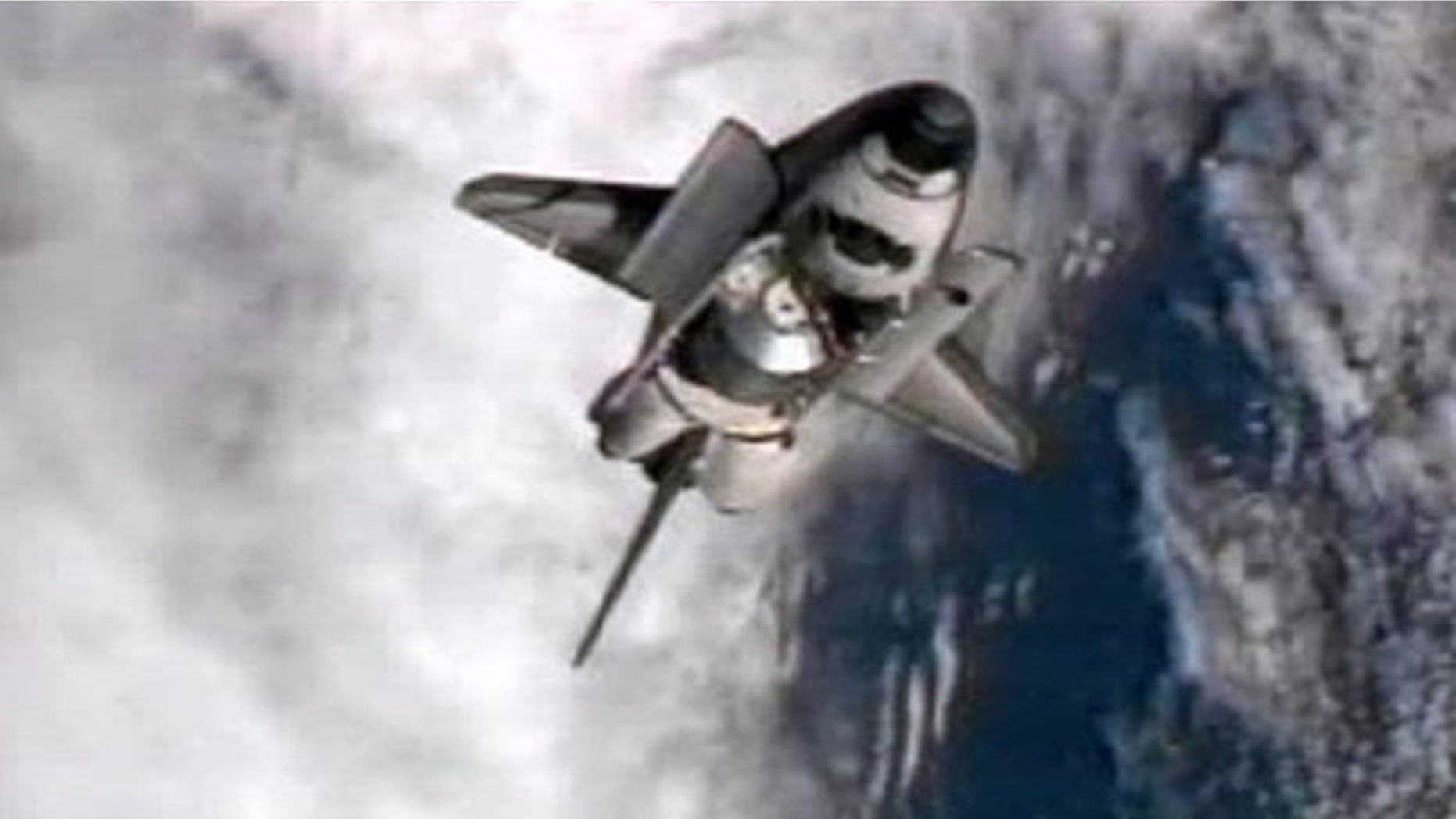July 10: This frame grab from NASA-TV shows space shuttle Atlantis performing a pitch maneuver as it closes in for one last docking at the International Space Station.