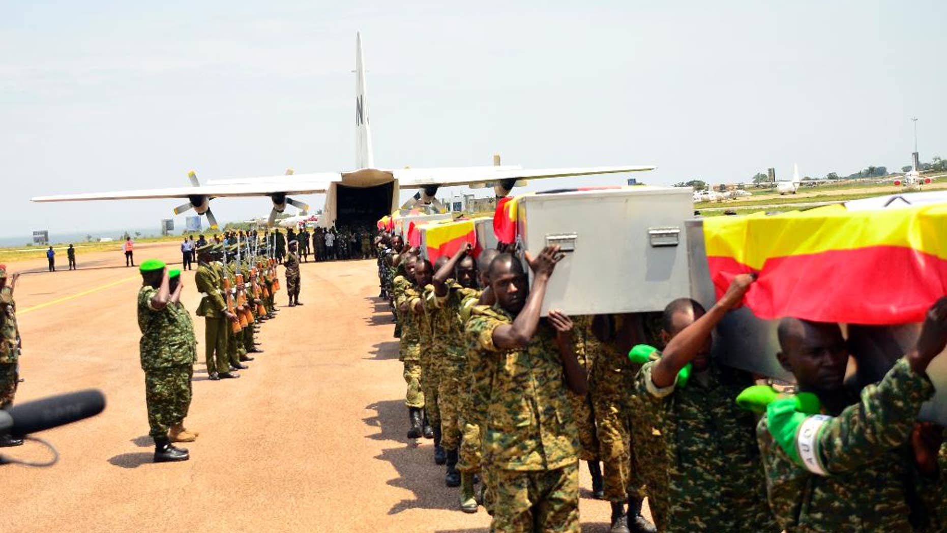 Ugandan soldiers carry the caskets of the Ugandan soldiers killed in Somalia, on arrival at Entebbe, Uganda, Thursday, Sept. 3, 2015. A Ugandan military spokesman says 12 Ugandan soldiers were killed in an attack Tuesday by Islamic extremists on an African Union base in Somalia. Lt. Col. Paddy Ankunda said Thursday that all soldiers were accounted for and that none was captured. He said 10 of the bodies will be flown back home Thursday. (AP Photo)