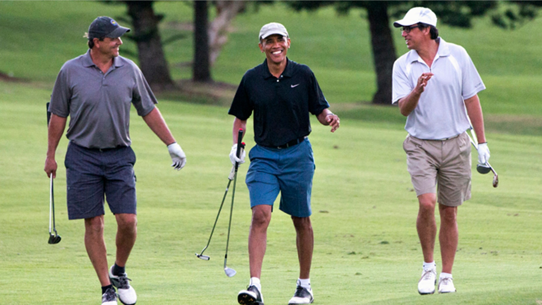 FILE - In this Dec. 29, 2014 file photo, President Barack Obama smiles while golfing with friends Greg Orme, left, and Mike Ramos, on the 18th hole of the Mid Pacific Country Club in Kailua, Hawaii during the Obama family vacation. Since returning to his childhood home this month on vacation, President Barack Obama has spent nearly every day cloistered with three people whose company puts him at ease. Its not his wife and daughters, who came with him, but a trio of pals whose friendship dates back to Obamas high school days in Hawaii. (AP Photo/Jacquelyn Martin, File)