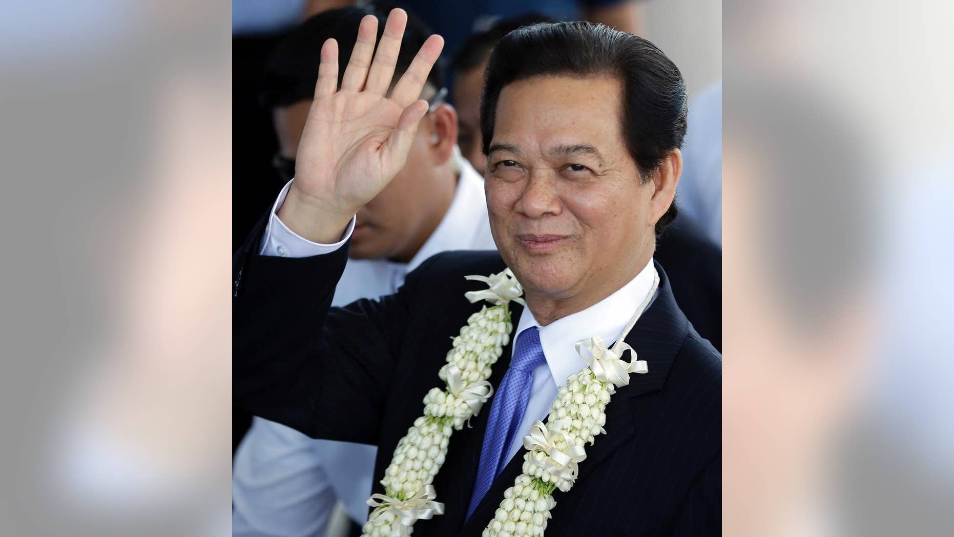 Vietnamese Prime Minister Nguyen Tan Dung waves to media shortly upon arrival at the Manila International Airport in Manila, Philippines Wednesday, May 21, 2014. Prime Minister Dung is here for the World Economic Forum in East Asia and for talks with Philippine President Benigno Aquino III that will focus on toughening cooperation as their countries wrangle with China in tense territorial standoffs in the South China Sea. (AP Photo/Bullit Marquez)