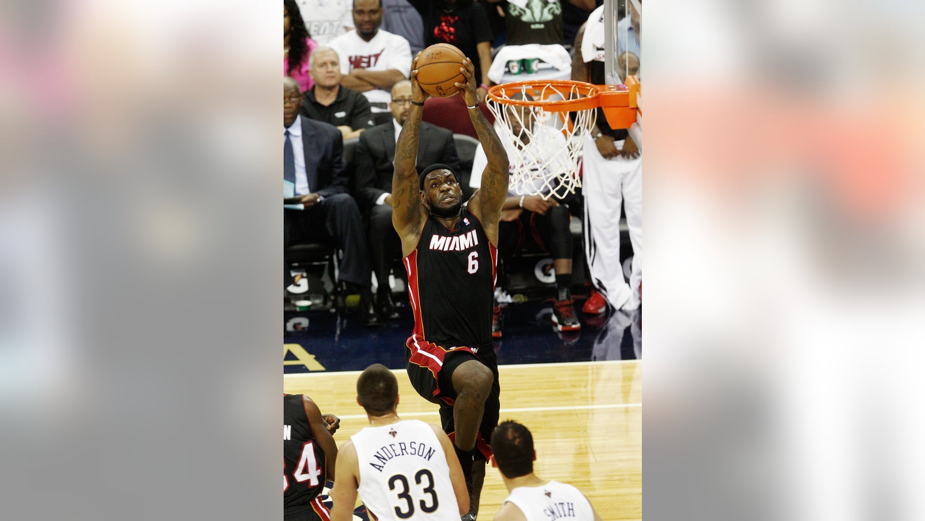 Miami Heat small forward LeBron James (6) drives to the basket against the New Orleans Pelicans in the first half of a preseason NBA basketball game in New Orleans, Wednesday, Oct. 23, 2013. (AP Photo/Bill Haber)