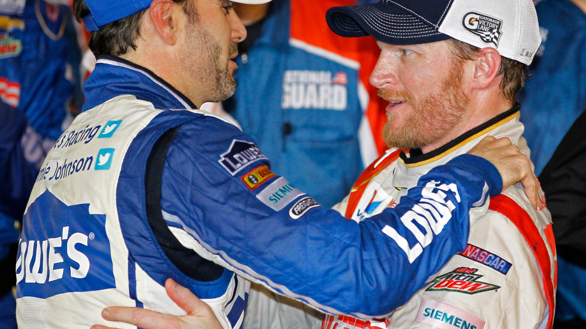 Dale Earnhardt Jr., right, celebrates in Victory Lane with teammate Jimmie Johnson, left, after winning the NASCAR Daytona 500 Sprint Cup series auto race at Daytona International Speedway in Daytona Beach, Fla., Sunday, Feb. 23, 2014. (AP Photo/Terry Renna)