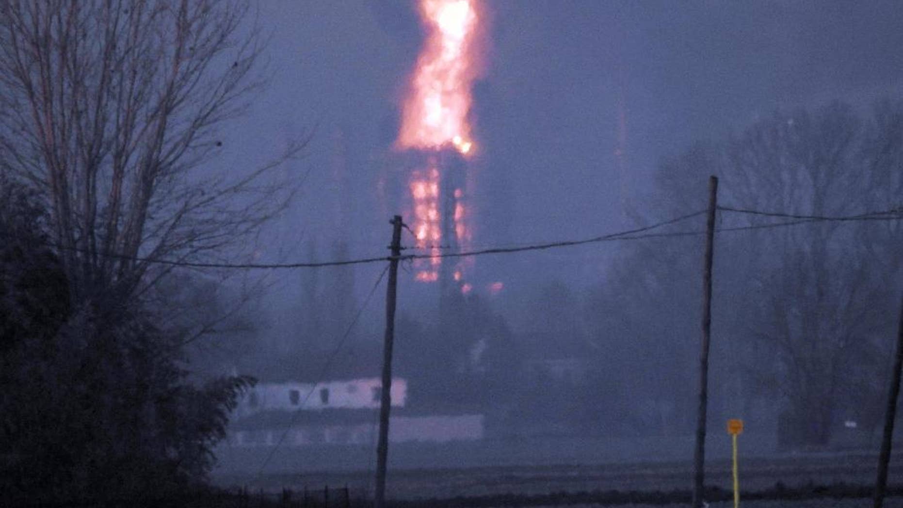 Flames and smoke billow following a blast in a refinery in Sannazzaro de Burgondi, near Pavia, northern Italy, Thursday, Dec. 1, 2016. Italian oil company Eni says a fire erupted in a refinery in Pavia province south of Milan, and that the flames were being extinguished. There were no immediate reports of injuries. (Dino Ferretti/ANSA via AP)