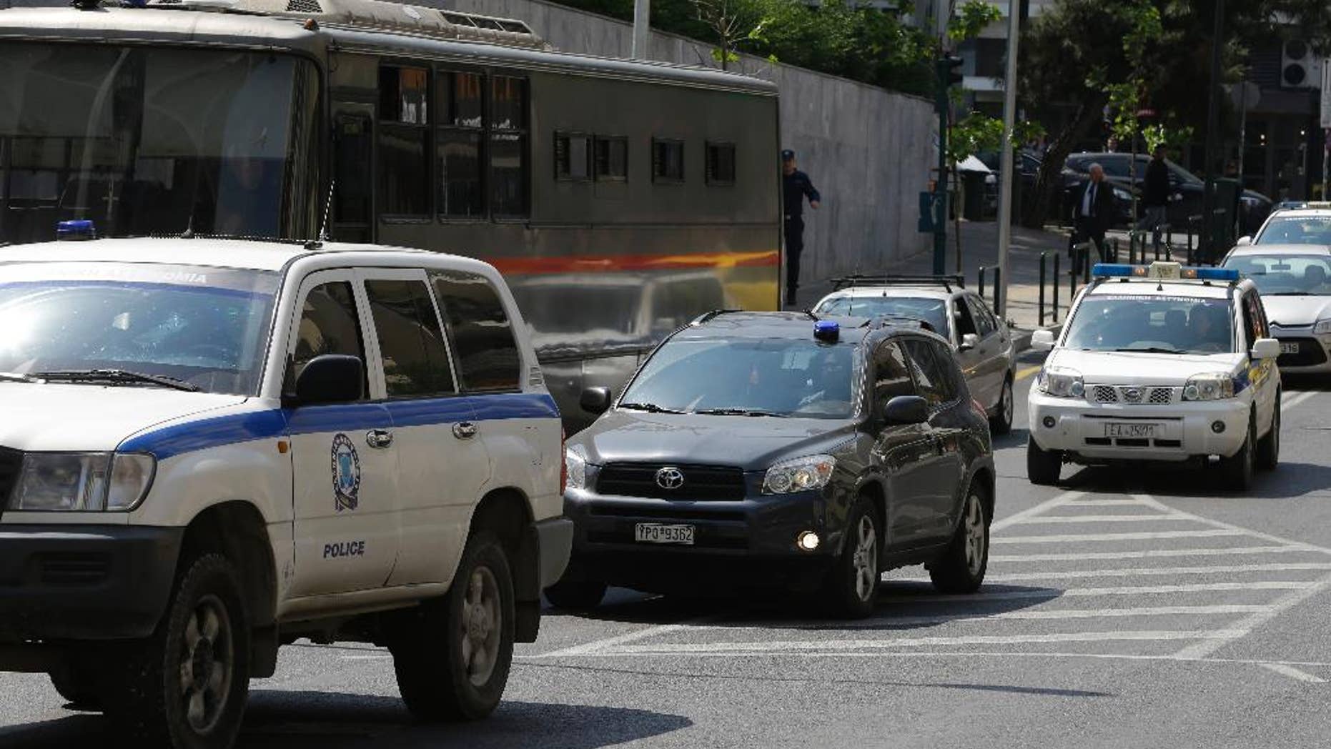 Three of the eight Turkish military officers are transferred in a police convoy to a court in Athens, Tuesday, April 25, 2017. Turkish servicemen who fled to Greece after last year's coup go back to court after Turkey submitted new evidence and re-issued their request for the servicemen's extradition. (AP Photo/Thanassis Stavrakis)