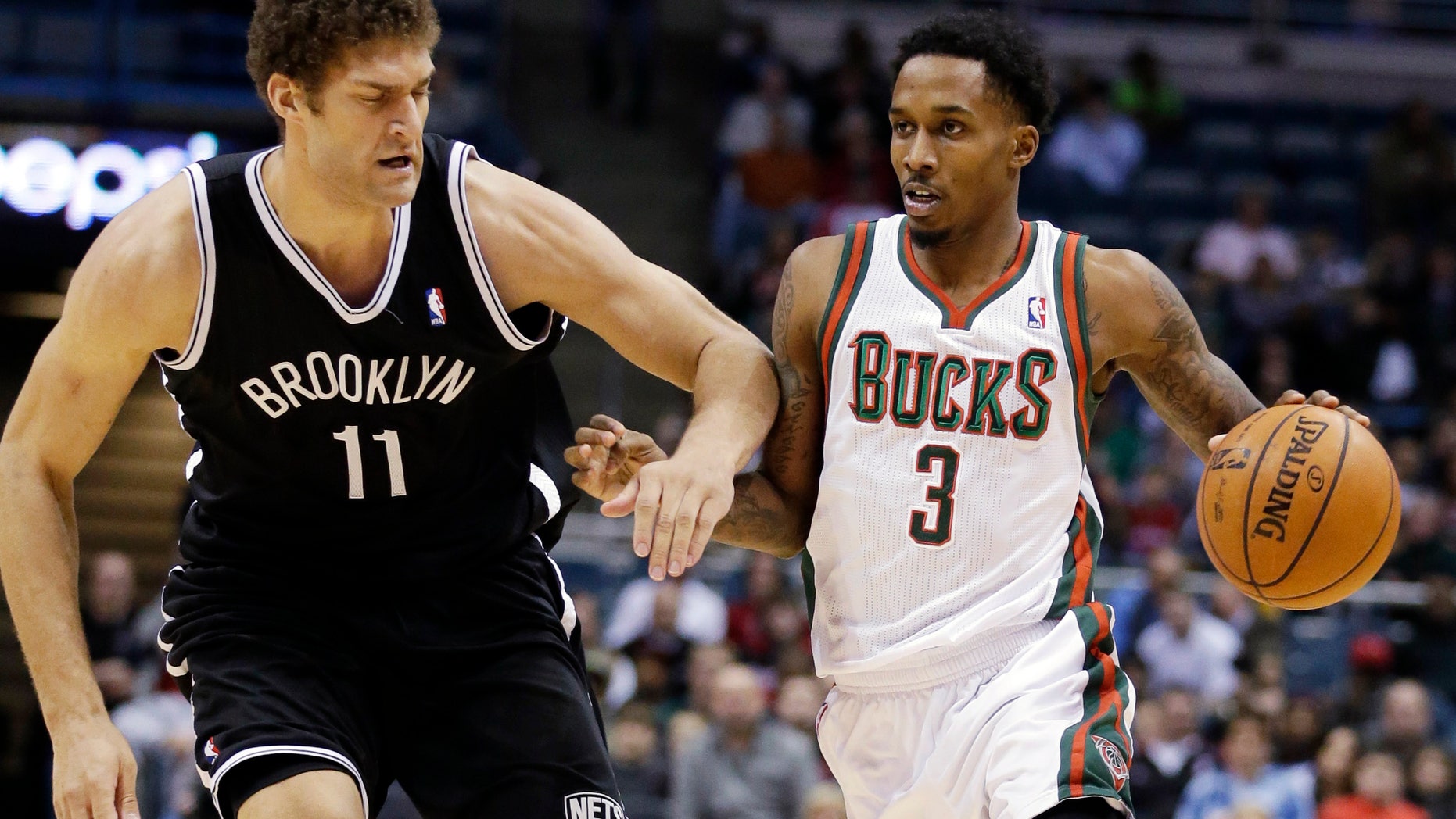 Milwaukee Bucks' Brandon Jennings (3) drives past Brooklyn Nets' Brook Lopez (11) during the second half of an NBA basketball game, Wednesday, Dec. 26, 2012, in Milwaukee. The Bucks won 108-93. (AP Photo/Morry Gash)