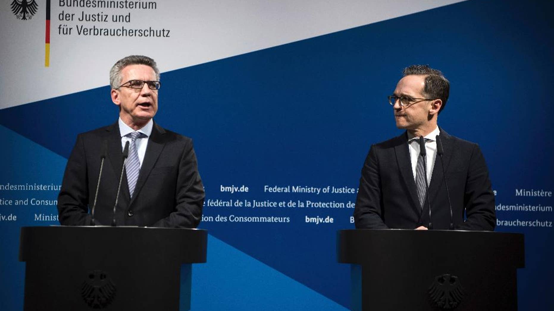 Germany's Interior Minister Thomas de Maizi're, left, and Justice Minister Heiko Maas attend a joint news conference in Berlin, Germany, Tuesday, Jan. 10, 2017. Germany’s interior and justice ministers agreed Tuesday to toughen the rules on deporting failed asylum-seekers and monitoring extremists in response to last month’s deadly truck attack on a Christmas market. (Bernd von Jutrczenka/dpa via AP)