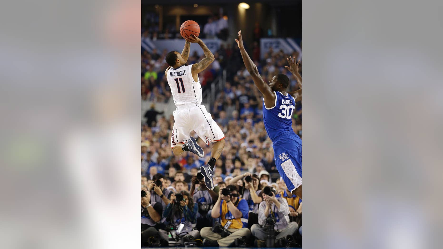 Connecticut guard Ryan Boatright, left, shoots over Kentucky forward Julius Randle during the second half of the NCAA Final Four tournament college basketball championship game Monday, April 7, 2014, in Arlington, Texas. (AP Photo/David J. Phillip)
