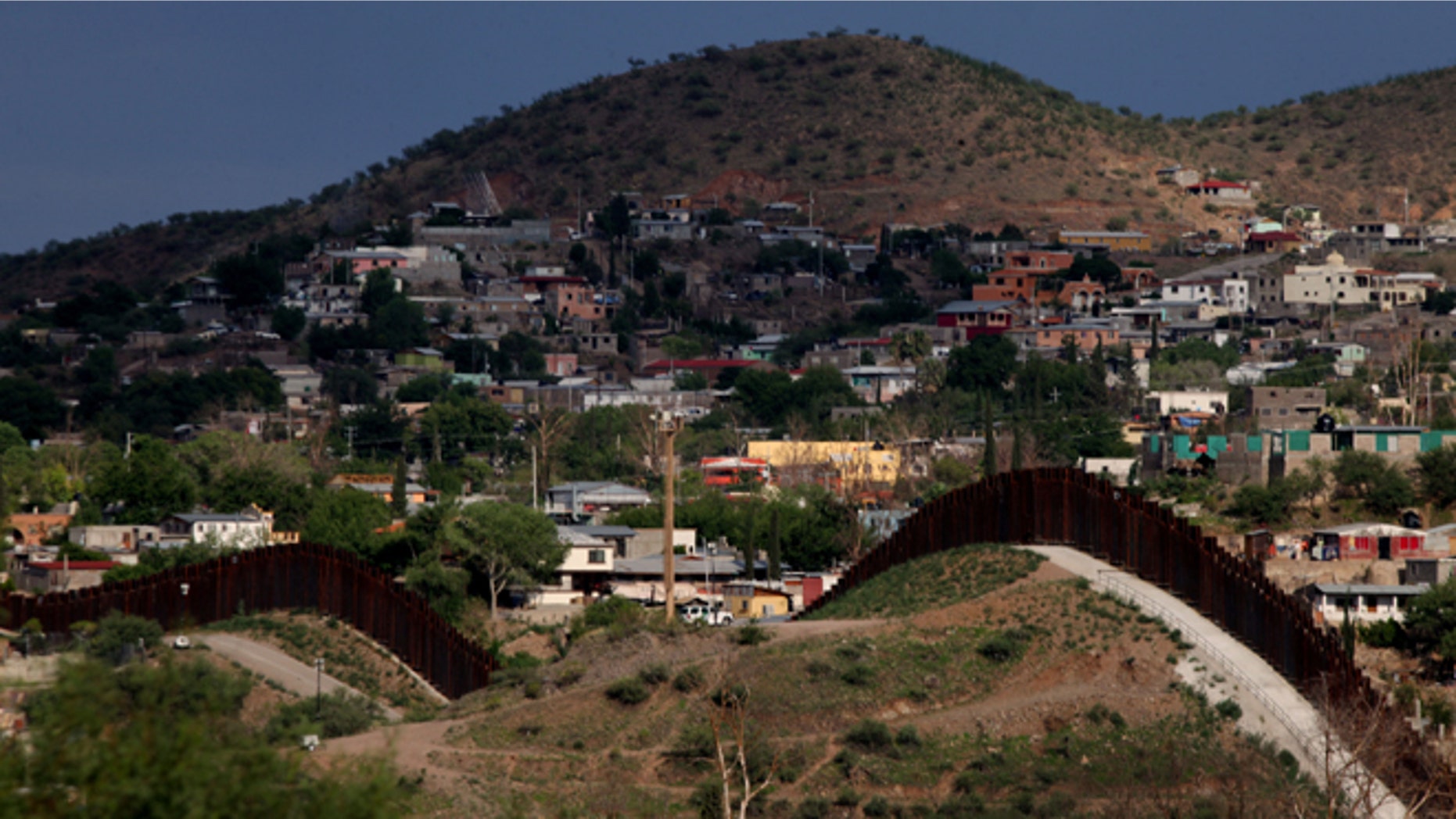 The U.S.- Mexico border wall in Nogales, Arizona. (Photo by Sandy Huffaker/Getty Images)