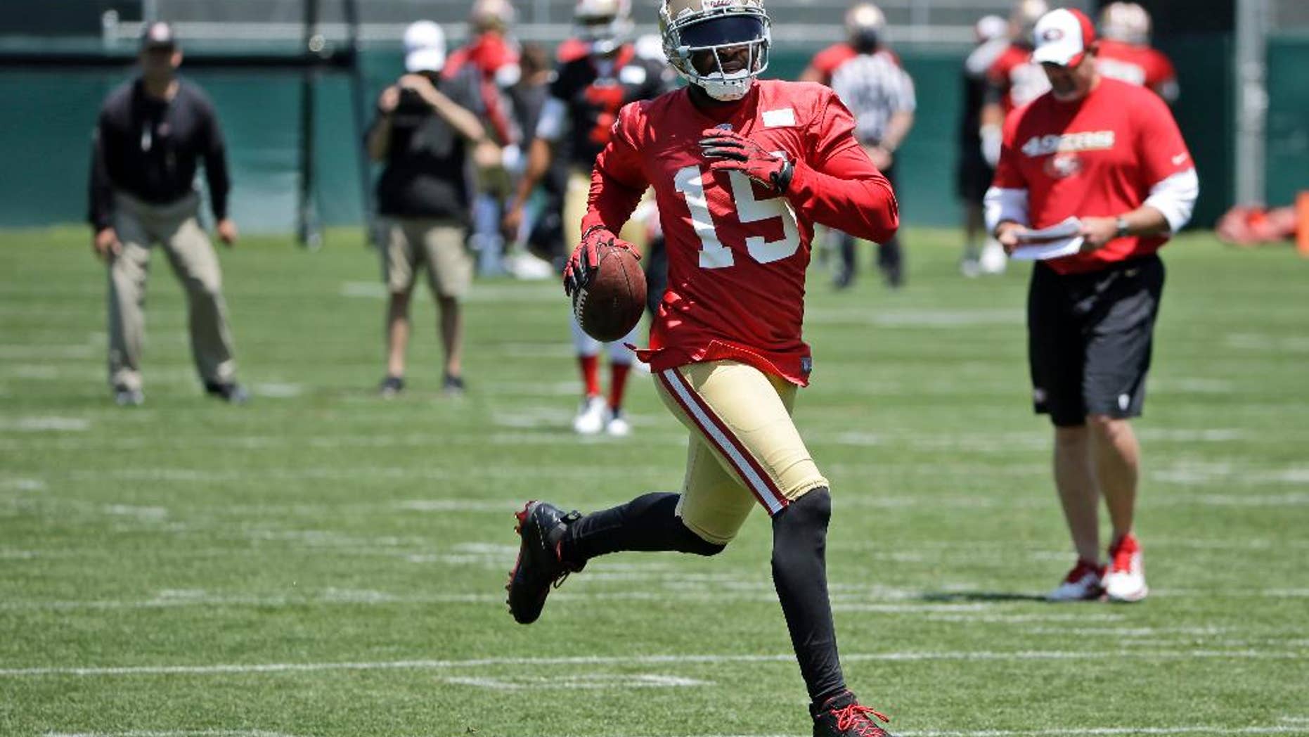 FILE - In this May 28, 2014, file photoo, San Francisco 49ers wide receiver Michael Crabtree runs after a reception during an NFL football pracice in Santa Clara, Calif. Crabtree has been looking forward to this for six seasons _ his first NFL game in his Dallas home. That chance comes Sunday in San Francisco's opener. And the star wide receiver is not about to let a calf injury stand in his way. (AP Photo/Marcio Jose Sanchez, File)
