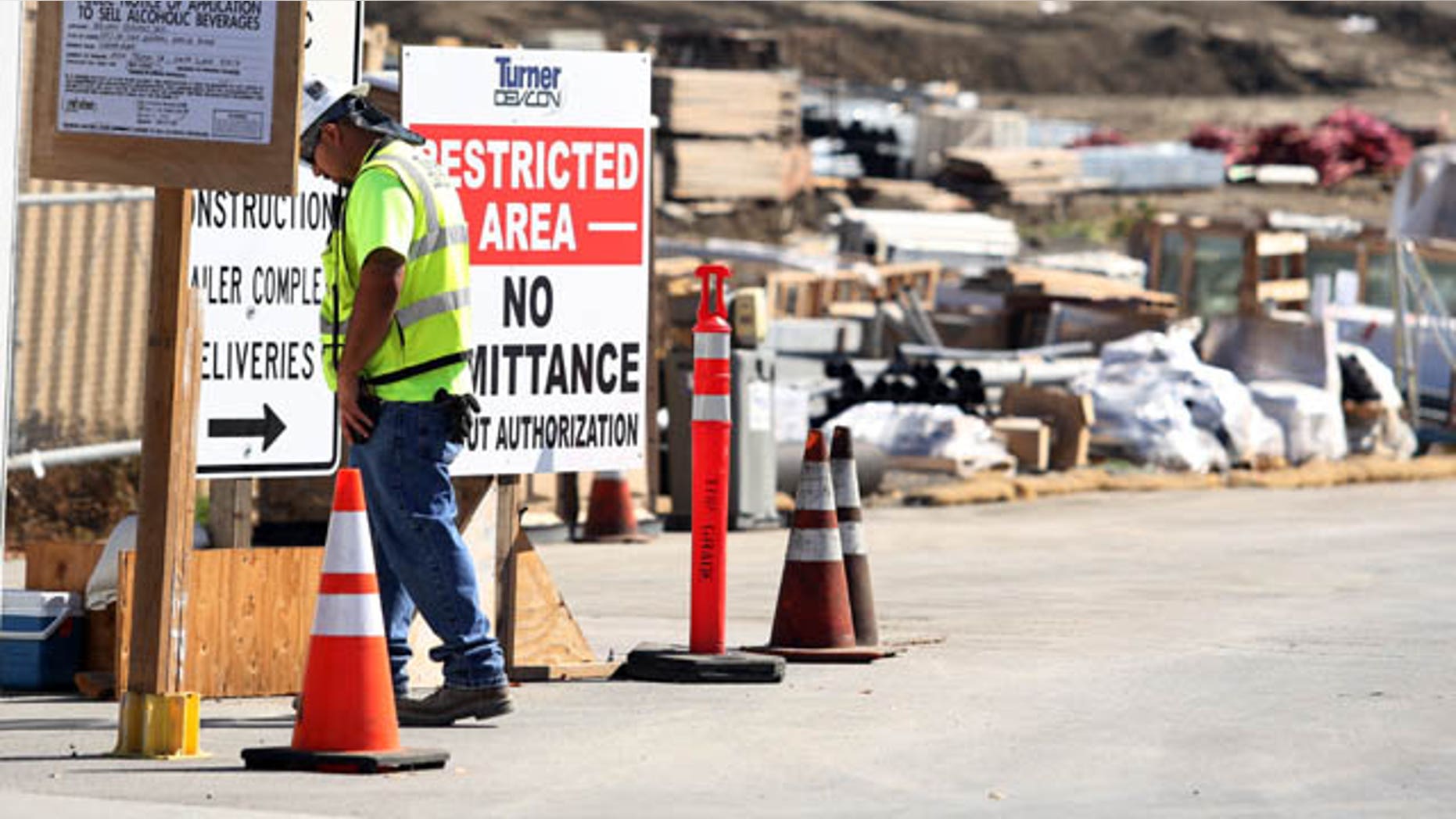 October 14, 2013: A security guard walks by a construction entrance at the Forty-Niners' new stadium Monday, Oct. 14, 2013, in Santa Clara, Calif., where a second worker has been killed in an accident in less than four months. (AP Photo)