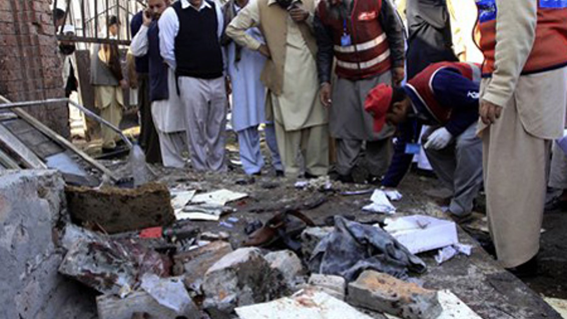 Nov. 19: People gather at the spot of a homicide bombing outside a courthouse in Peshawar, Pakistan.