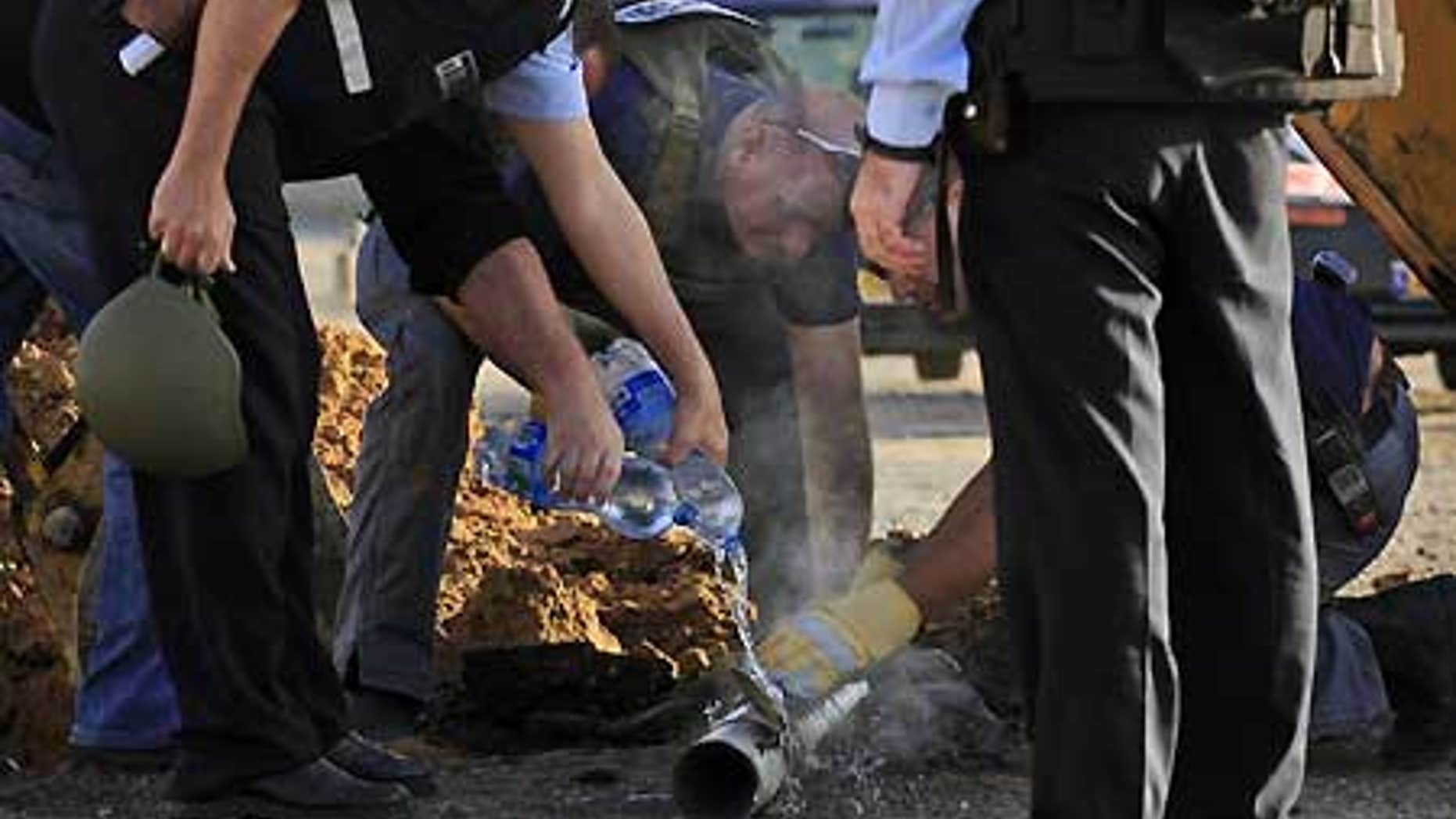 Feb. 3: Israeli police examine the remains of a rocket fired by Palestinian militants from the Gaza Strip, in the southern Israeli city of Ashkelon.