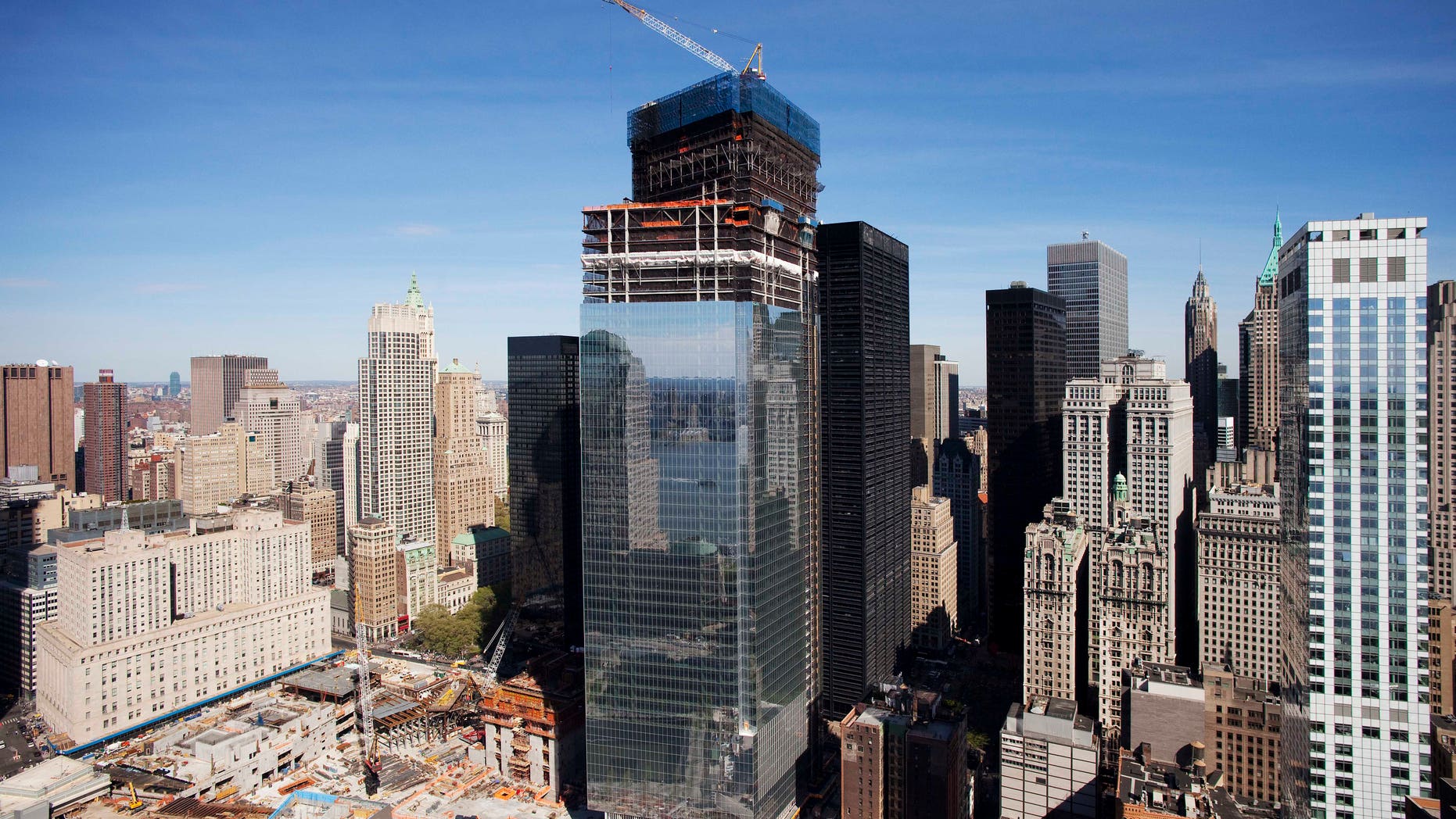 In a April 17, 2012 photo, Four World Trade Center, center, rises above the World Trade Center construction site, in New York.