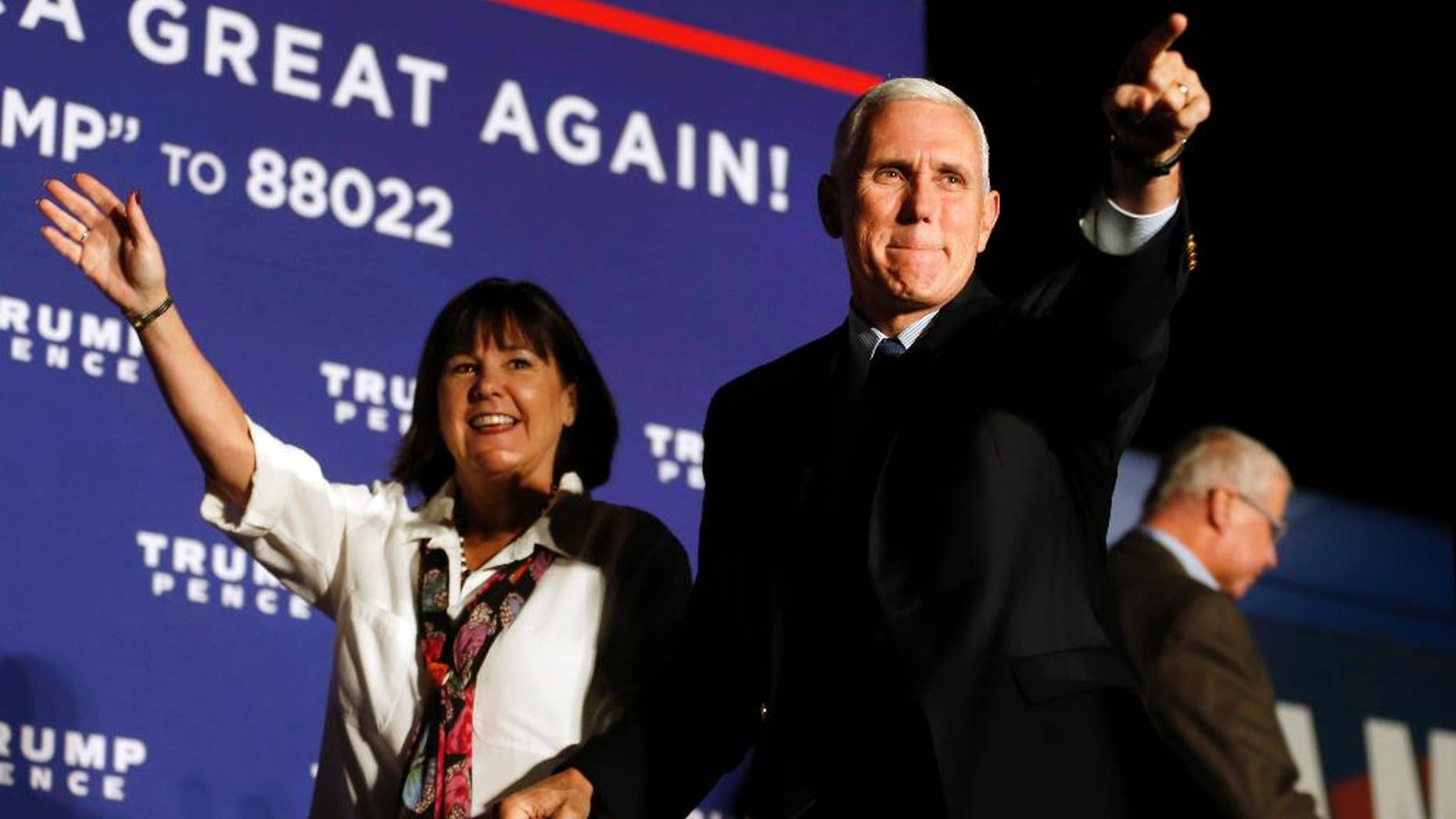 Republican vice presidential nominee Indiana Gov. Mike Pence, arrives with his wife, Karen, at a campaign rally at Cox Transportation Services in Ashland, Va., Monday Oct. 3, 2016. (Shelby Lum/Richmond Times-Dispatch via AP)