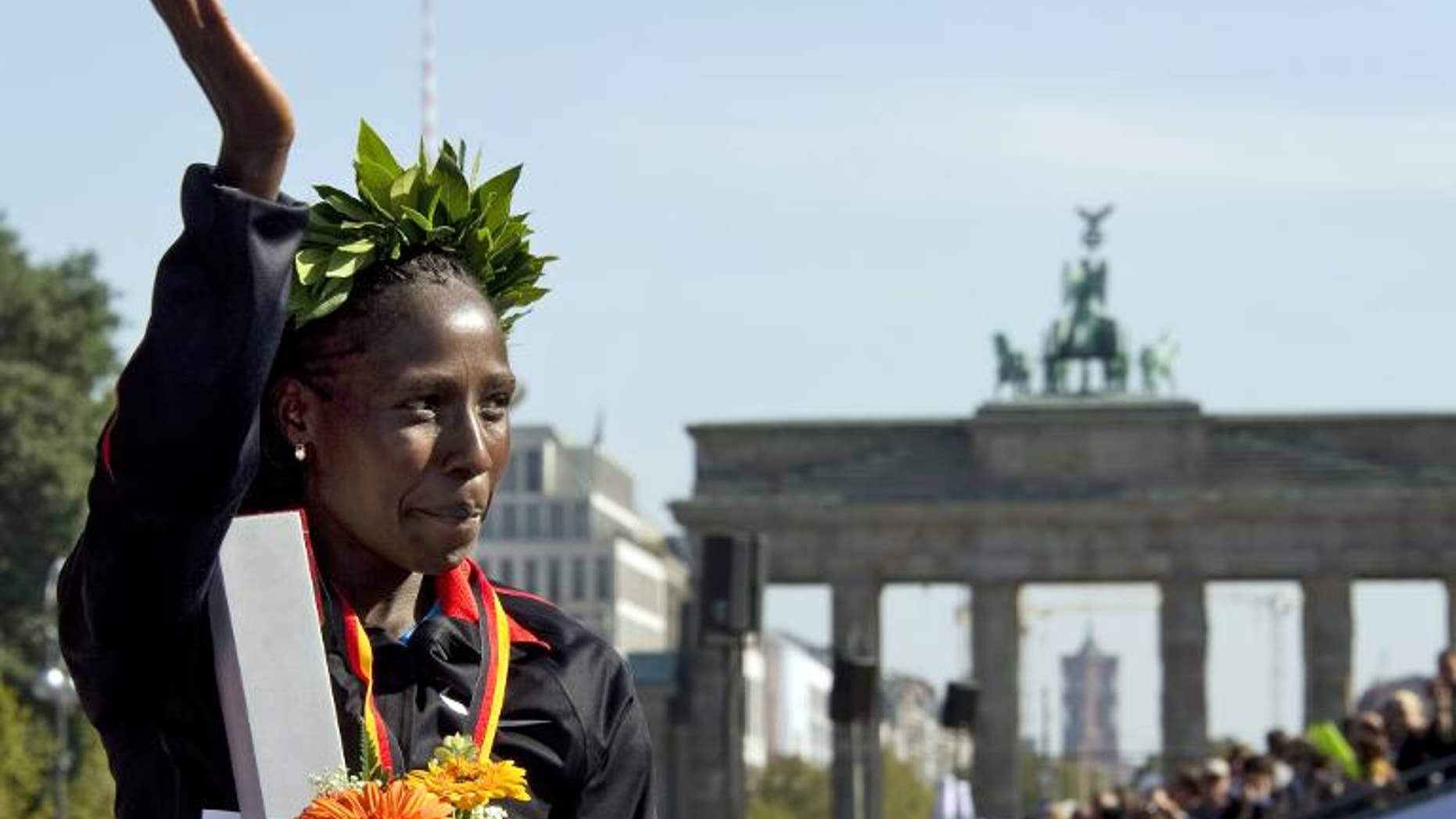 Florence Kiplagat of Kenya celebrates after the 38th Berlin Marathon on September 25, 2011