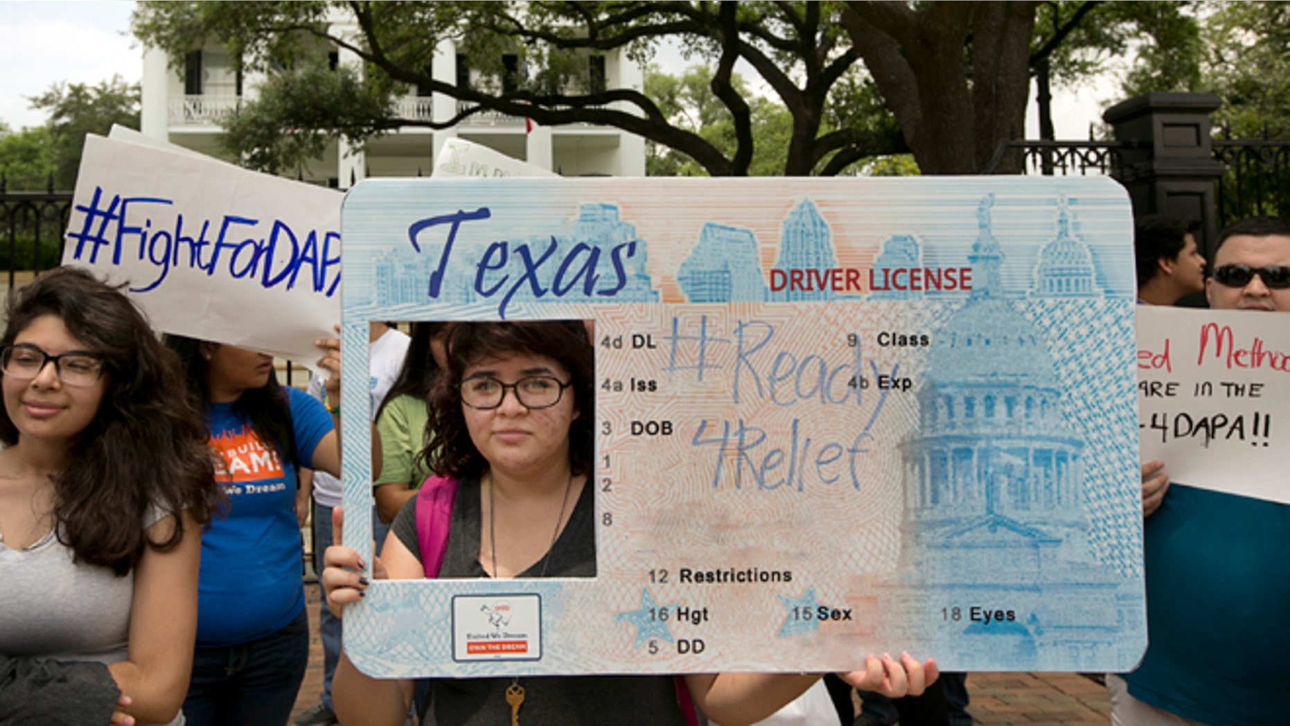 Alondra Chavez, 17, of Pasadena, Texas, and other immigrant rights activists protest outside the Governor's Mansion in Austin, Texas, on Tuesday May 19, 2015. The group was protesting the Texas lawsuit against the Deferred Action for Parents of Americans, also known as DAPA, which would have gone into effect on Tuesday. (Jay Janner/Austin American-Statesman via AP)