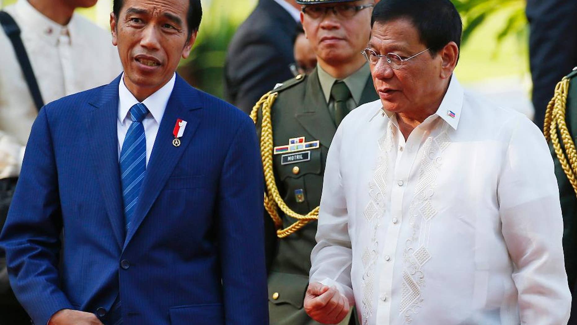 Indonesian President Joko "Jokowi" Widodo, left, chats with Philippine President Rodrigo Duterte following a welcoming ceremony at the Malacanang Palace grounds in Manila, Philippines, Friday, April 28, 2017. Widodo is attending the 30th ASEAN Leaders' Summit which the Philippines is hosting. (AP Photo/Bullit Marquez)
