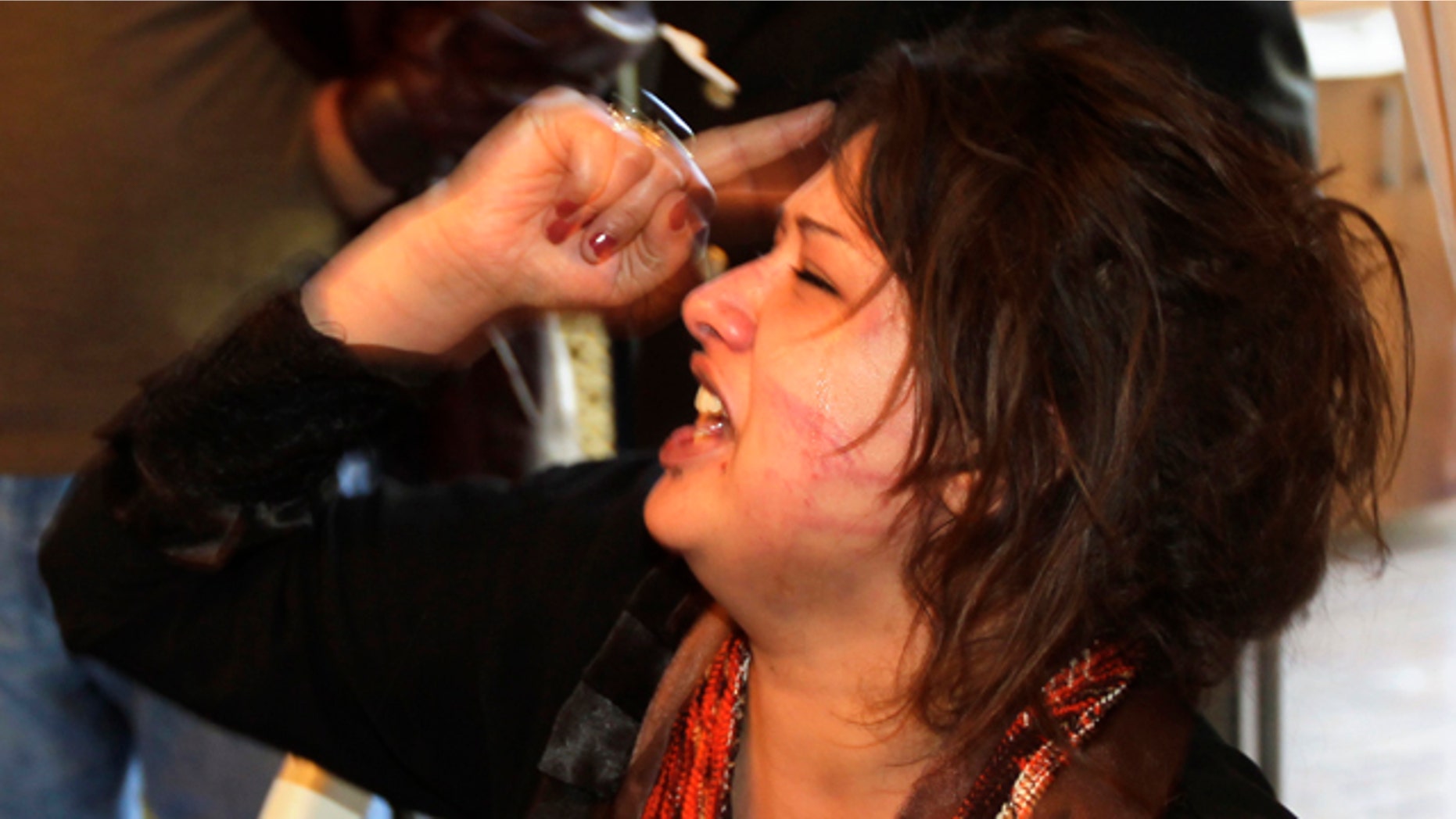 March 26: Iman Al-Obeidi is seen in Tripoli after storming into a hotel's breakfast room to show her wounds to foreign media.