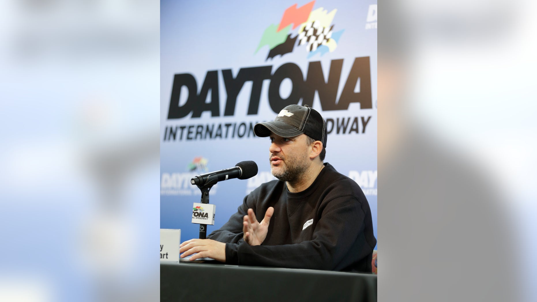 NASCAR driver Tony Stewart answers questions at a news conference during Sprint Cup auto racing testing at Daytona International Speedway in Daytona Beach, Fla., Thursday, Jan. 9, 2014.(AP Photo/John Raoux)