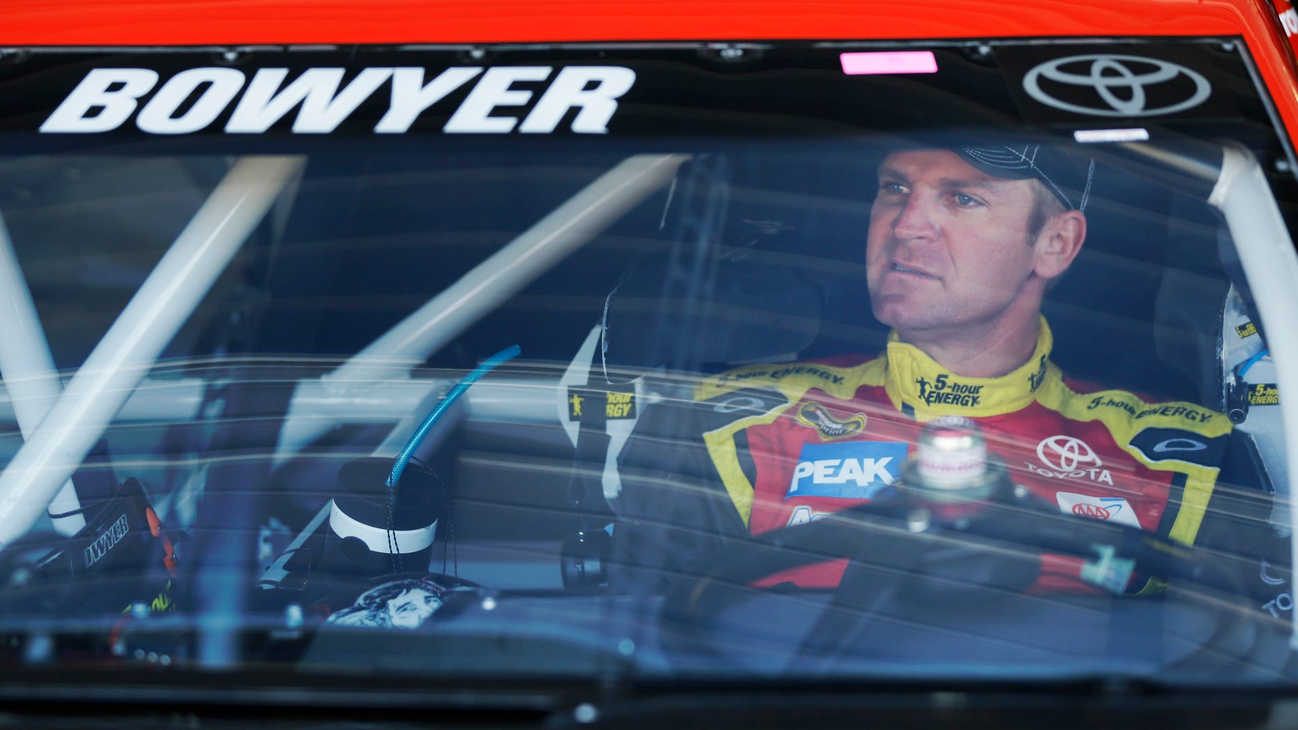FILE - In this April 19, 2013 file photo, Clint Bowyer waits for the start of practice for the NASCAR Sprint Cup series auto race at Kansas Speedway in Kansas City, Kan. Bowyer was always popular among his peers. A change of scenery to Michael Waltrip Racing has now made him one of NASCAR's stars. (AP Photo/Orlin Wagner, File)