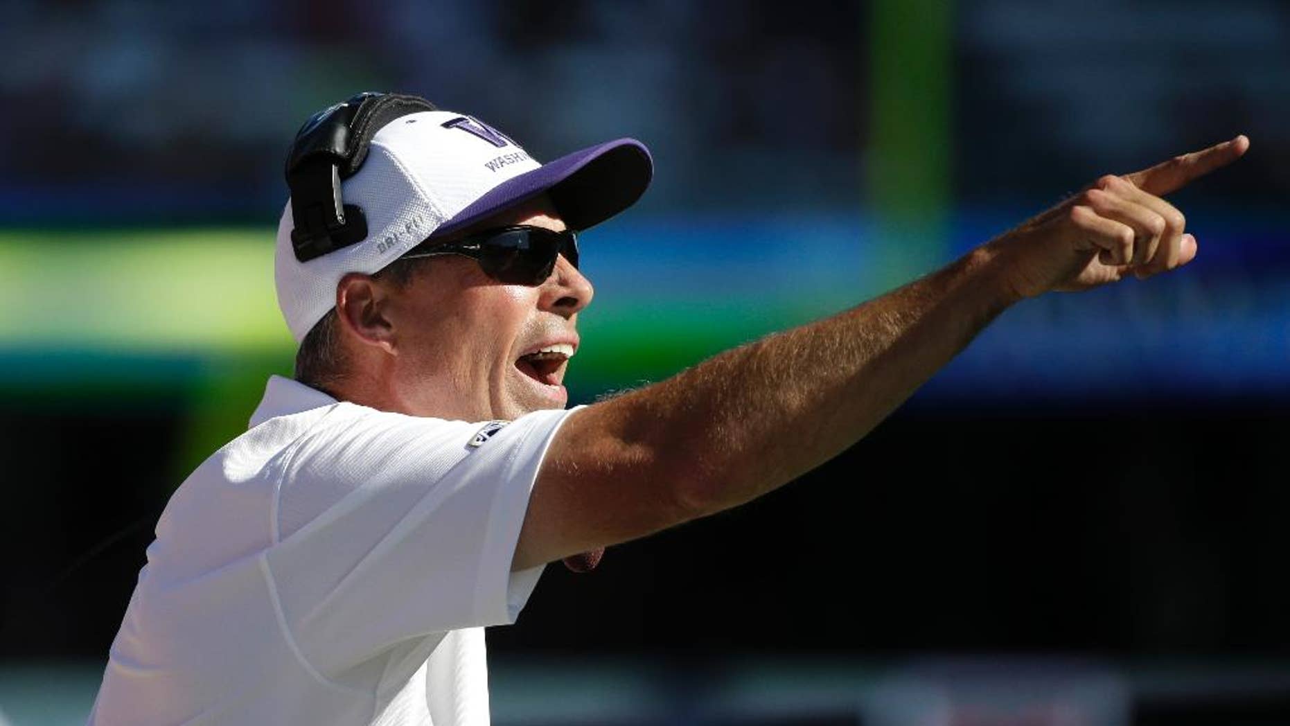 Washington Huskies head coach Chris Petersen yells toward the field in the second half of an NCAA football game Saturday, Sept. 6, 2014, in Seattle. Washington won 59-52. (AP Photo/Elaine Thompson)