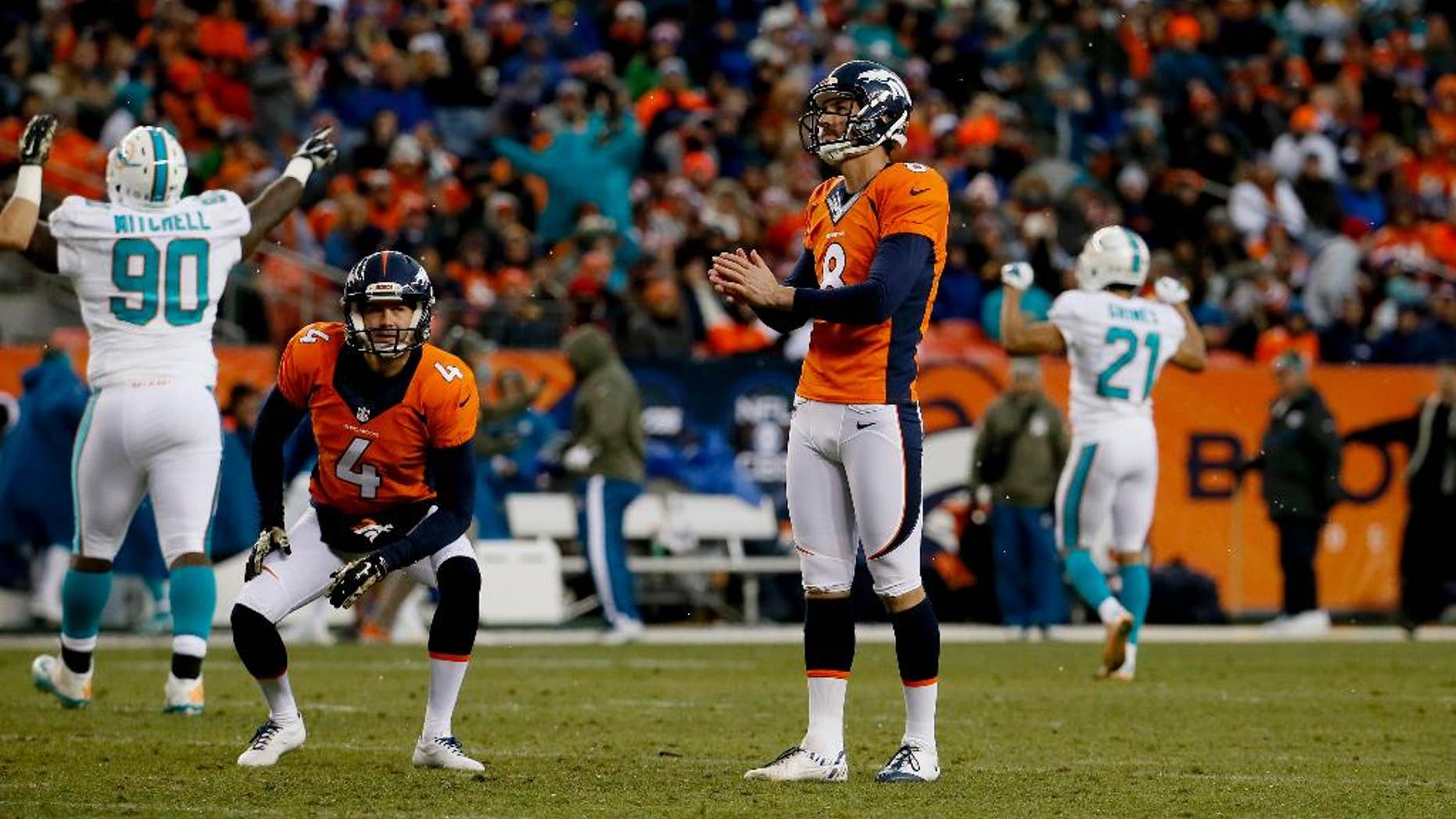 Miami Dolphins quarterback Ryan Tannehill (17) warms up prior to an NFL football game against the Denver Broncos, Sunday, Nov. 23, 2014, in Denver. (AP Photo/Joe Mahoney)